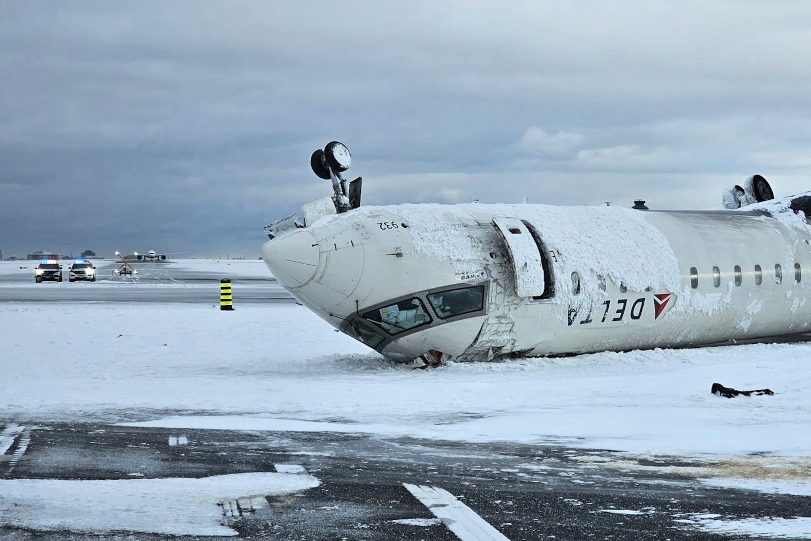 In this image provided by the National Transportation Safety Board, the wreckage of a Delta Air Lines jet rests upside down, Tuesday, Feb. 18, 2025, after it burst into flames and flipped upside down as it tried to land on Feb. 17, at Toronto Pearson International Airport in Mississauga, Ontario. (National Transportation Safety Board via AP)