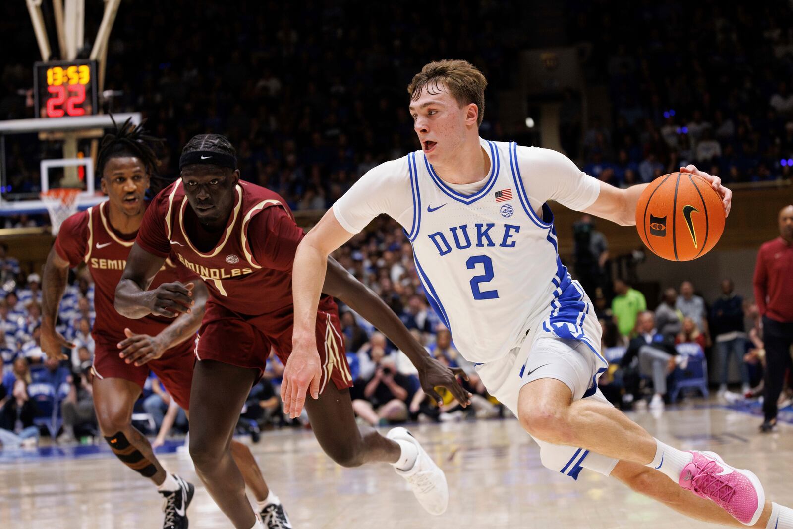 Duke's Cooper Flagg (2) drives past Florida State's Jerry Deng, second from left, during the second half of an NCAA college basketball game in Durham, N.C., Saturday, March 1, 2025. (AP Photo/Ben McKeown)