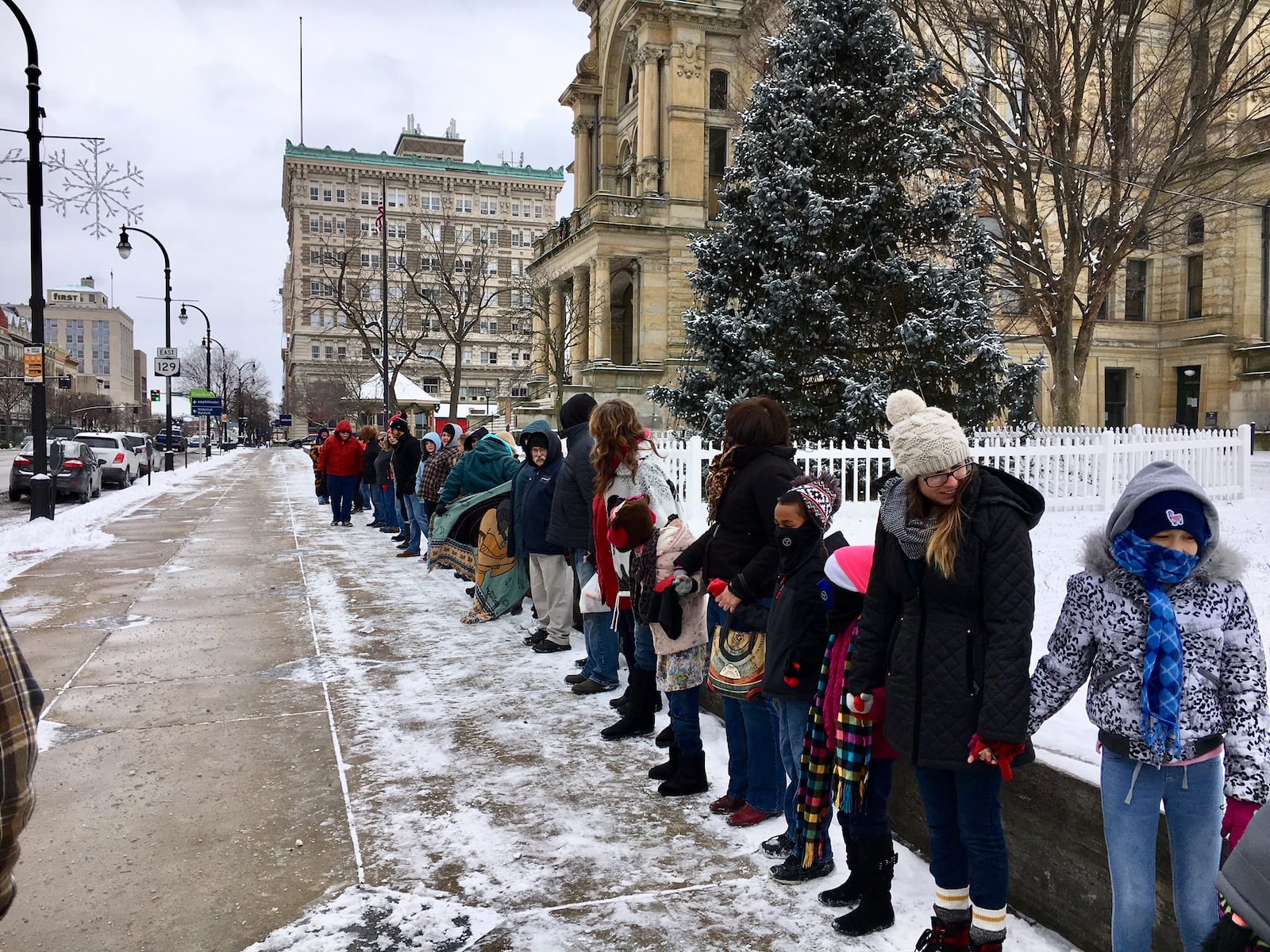 More than 60 area residents braved frigid cold Saturday to join hands in unity formation at the urging of the Hamilton City’s popular “Dancing Trucker.” Among the supporters of John Drury was Hamilton Mayor Pat Moeller.(Photo by Michael D. Clark)