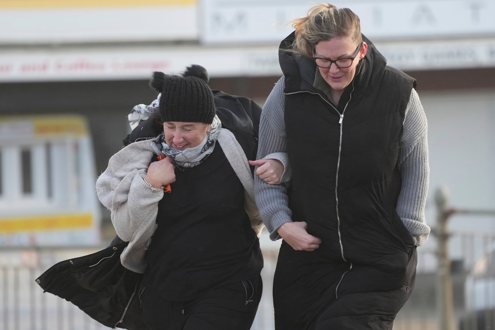 Two women brave the wind as Storm Eowyn hits the country in Cleveleys, near Blackpool, England, Friday, Jan. 24, 2025.(AP Photo/Jon Super)