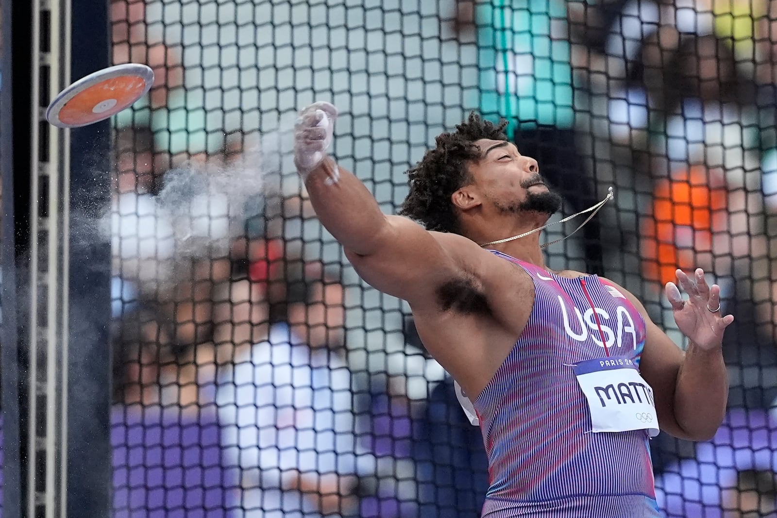 FILE - Sam Mattis, of the United States, competes during the men's discus throw qualification at the 2024 Summer Olympics, Aug. 5, 2024, in Saint-Denis, France. (AP Photo/Matthias Schrader, File)