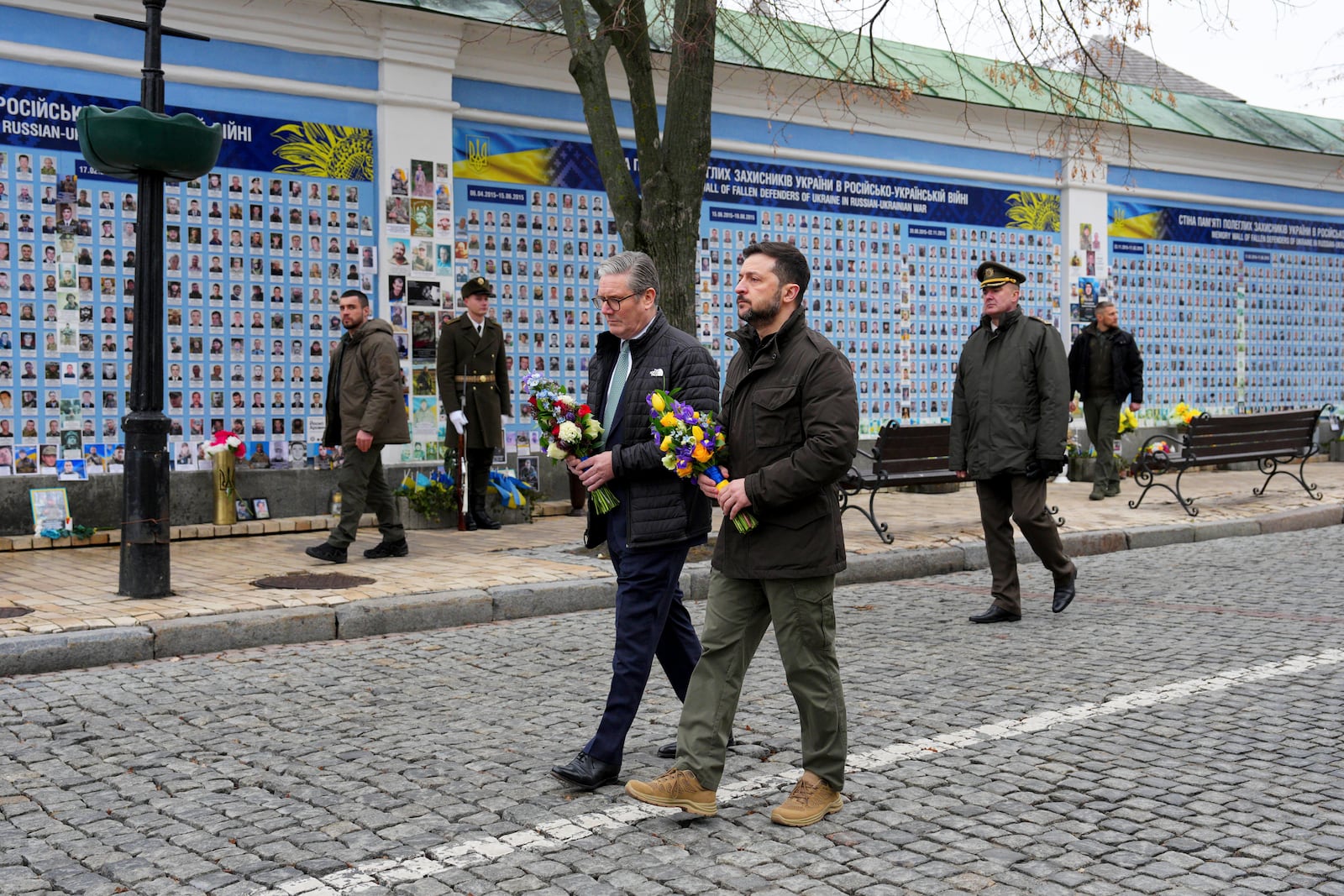 British Prime Minister Keir Starmer and Ukrainian President Volodymyr Zelenskyy arrive to lay wreaths at The Wall of Remembrance of the Fallen for Ukraine, in Kyiv, Ukraine Thursday, Jan. 16, 2025. (Carl Court/Pool Photo via AP)