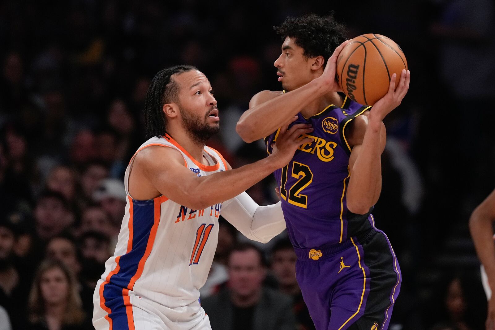 New York Knicks' Jalen Brunson (11) defends Los Angeles Lakers' Max Christie (12) during the first half of an NBA basketball game Saturday, Feb. 1, 2025, in New York. (AP Photo/Frank Franklin II)