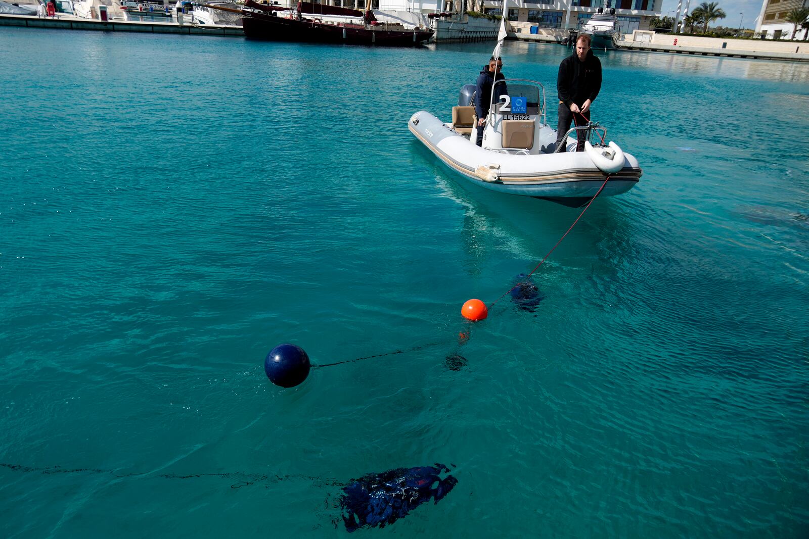 Underwater drones are seen inside the seawater next of an assist boat with two personnel, during a demonstration at a Marina in southern resort of Ayia Napa, Cyprus, Monday, February. 24, 2025. (AP Photo/Petros Karadjias)