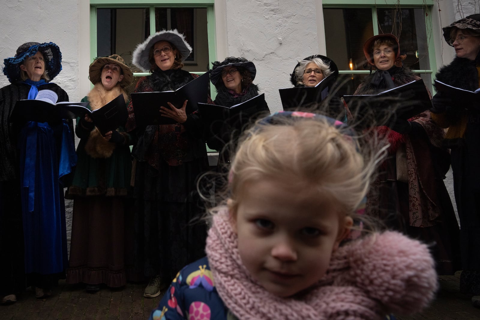 People in costumes from Charles Dickens' 19th-century English era sing, during a Dickens Festival, in Deventer, Netherlands, Saturday, Dec. 14, 2024. (AP Photo/Peter Dejong)