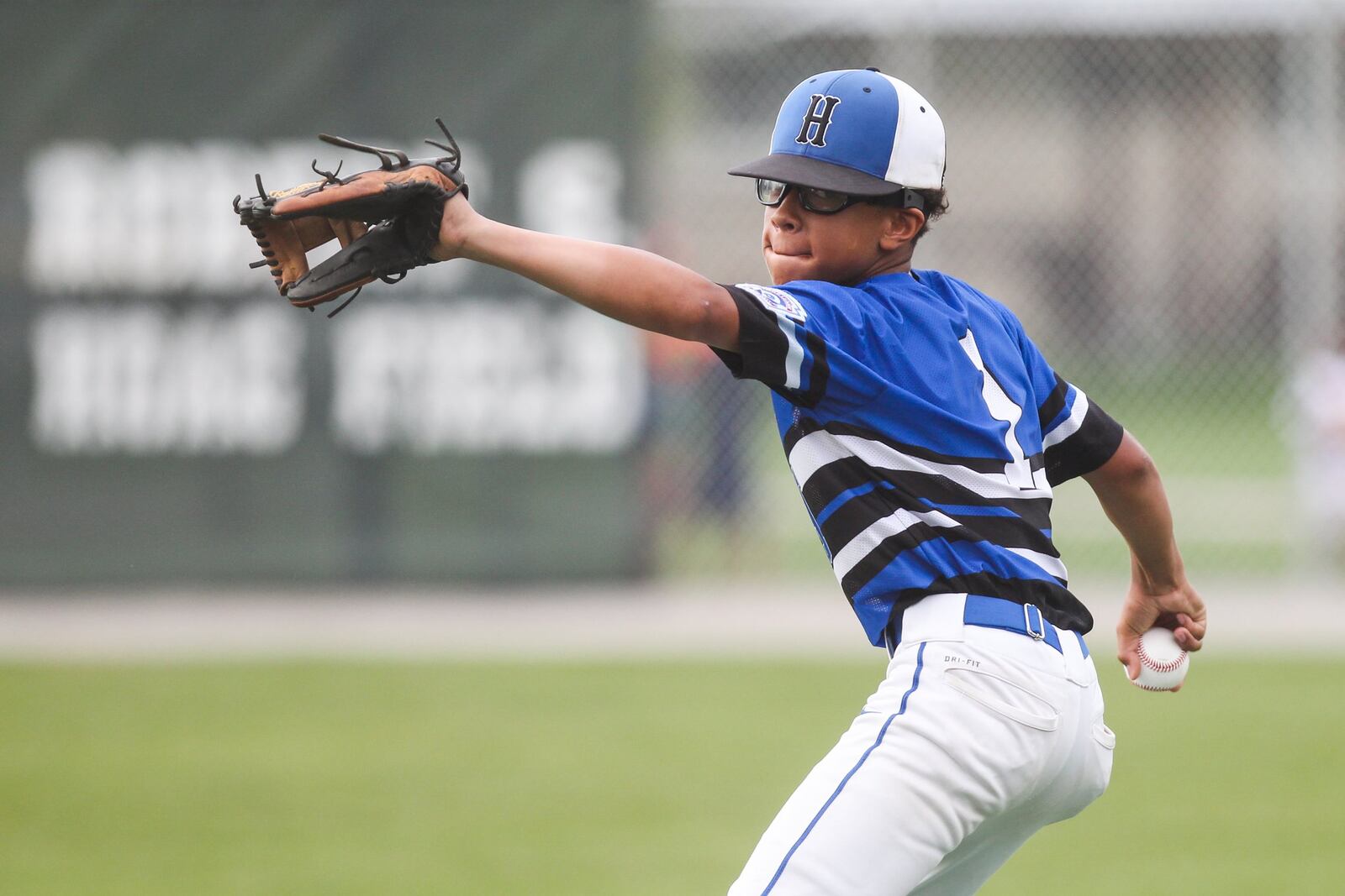 Hamilton West Side’s Braedyn Moore winds up to throw a pitch Thursday during the winners’ bracket final against Canfield in the Ohio Little League 12-year-old baseball tournament at Ford Park in Maumee. CONTRIBUTED PHOTO BY SCOTT GRAU