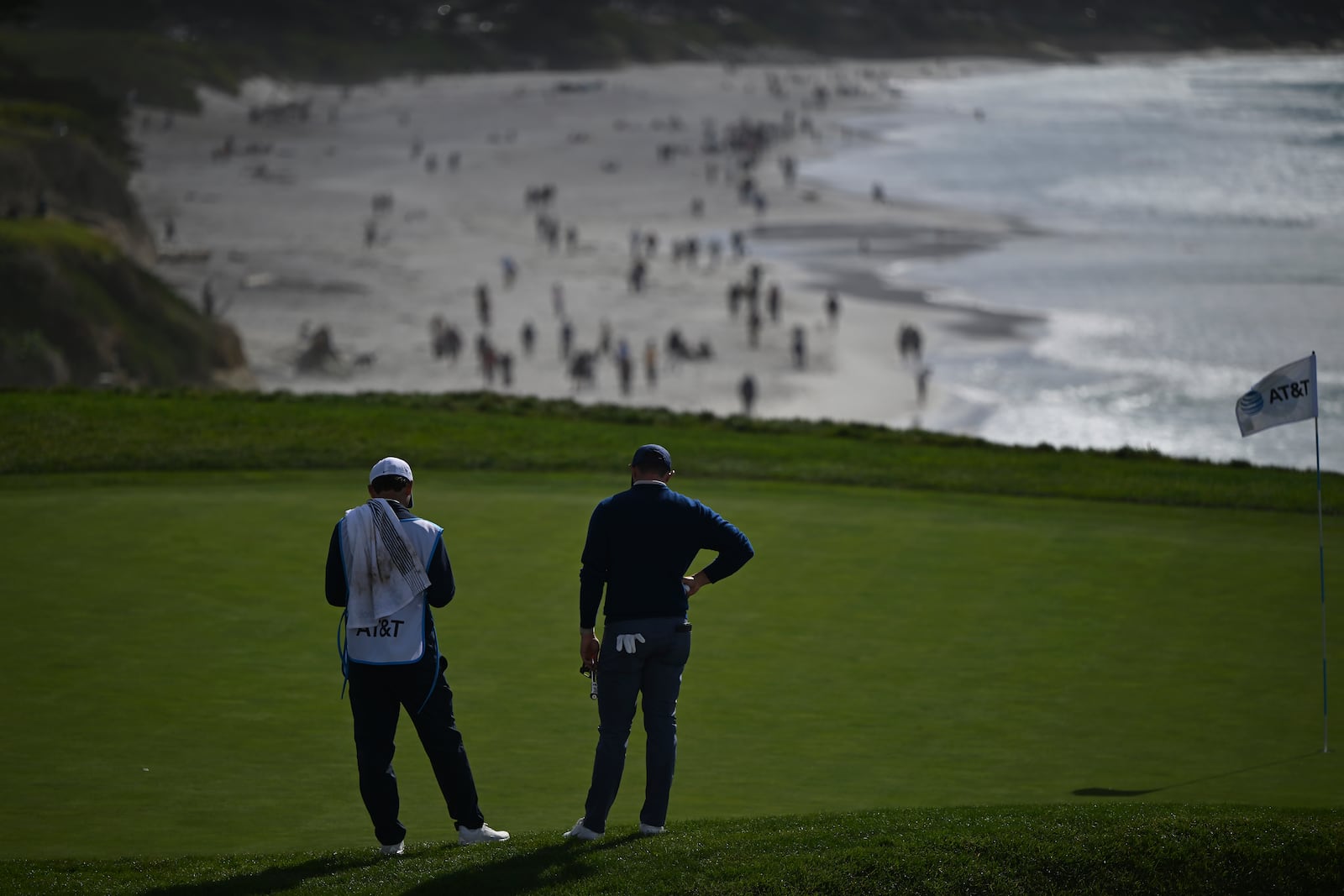 Rory McIlroy, of Northern Ireland, right, waits to putt on the ninth green at Pebble Beach Golf Links during the final round of the AT&T Pebble Beach Pro-Am golf tournament, Sunday, Feb. 2, 2025, in Pebble Beach, Calif. (AP Photo/Nic Coury)