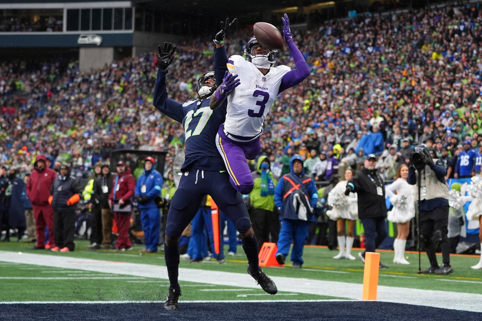 Seattle Seahawks cornerback Riq Woolen (27) breaks up a pass intended for Minnesota Vikings wide receiver Jordan Addison (3) during the first half of an NFL football game, Sunday, Dec. 22, 2024, in Seattle. (AP Photo/Lindsey Wasson)