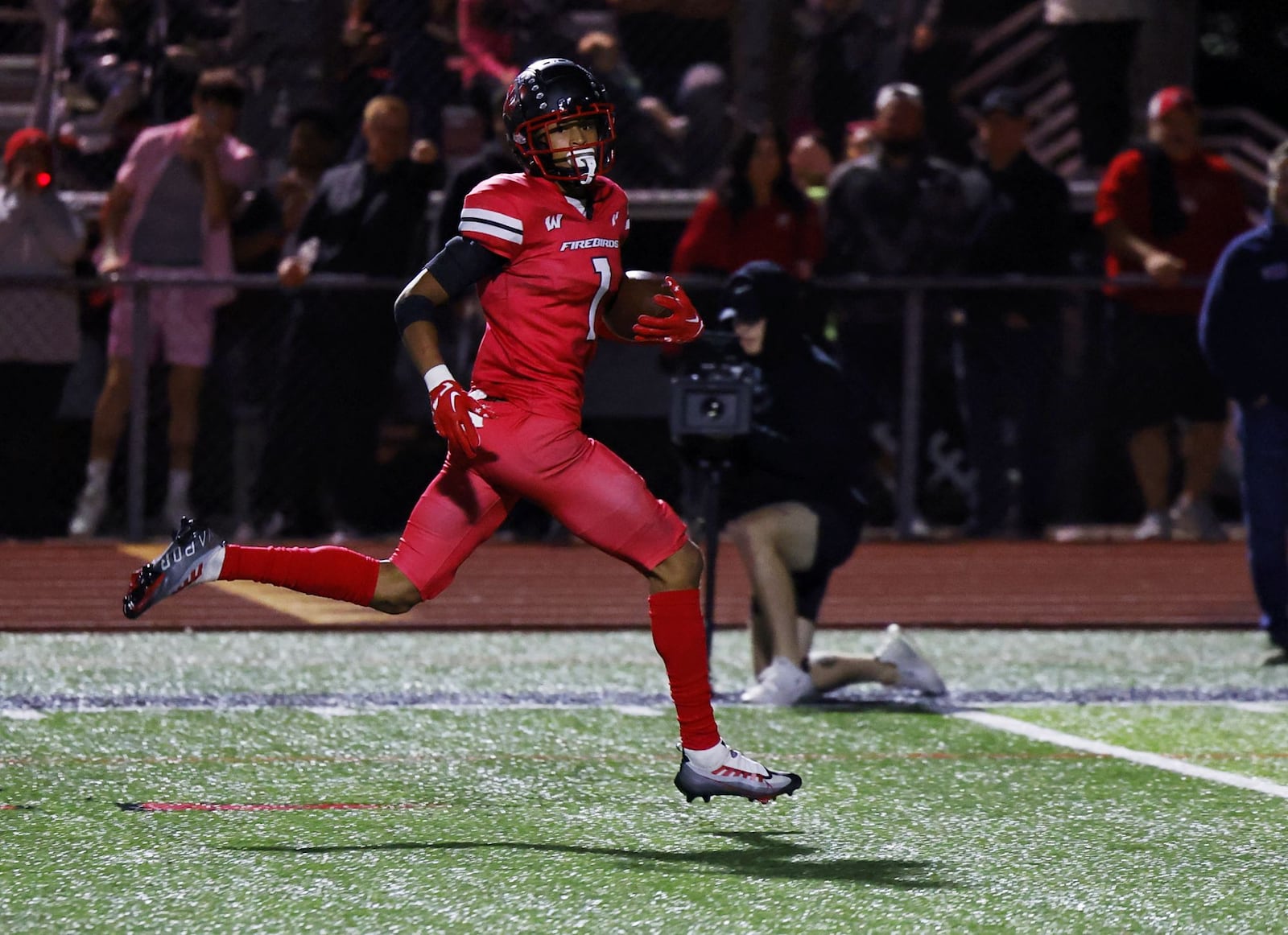 Lakota West defensive back Malik Hartford returns an interception for a touchdown during their football game Friday, Sept. 30, 2022 at Lakota West High School in West Chester Township. Lakota West defeated Mason 37-7. NICK GRAHAM/STAFF