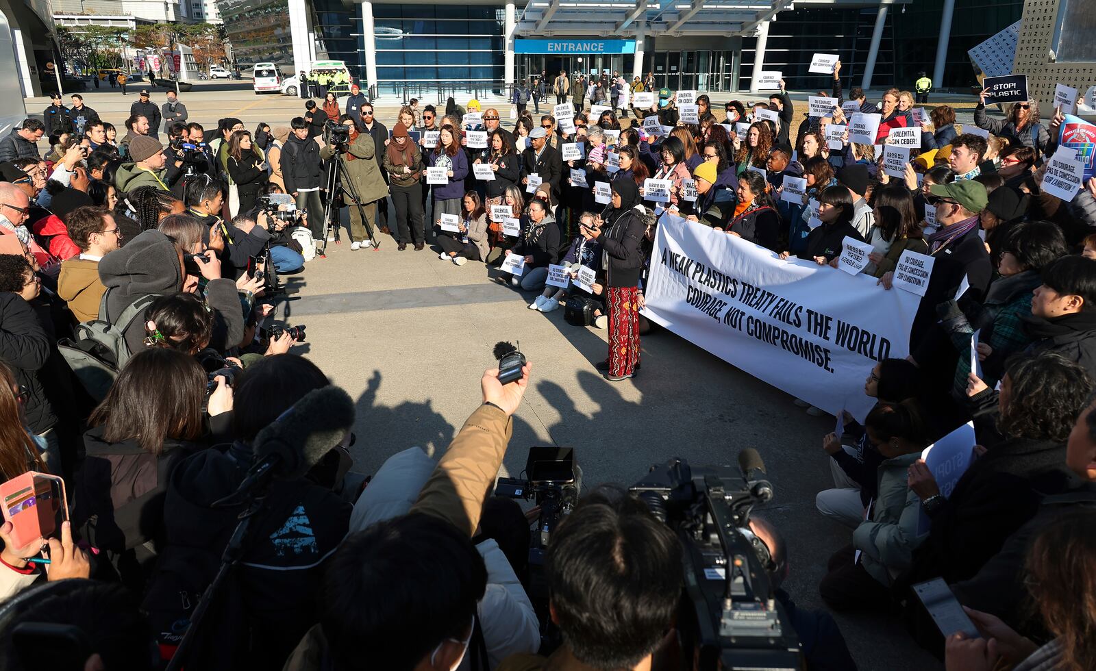 Environment activists hold a press conference calling for a strong global plastics treaty outside of the venue for the fifth session of the Intergovernmental Negotiating Committee on Plastic Pollution in Busan, South Korea, Friday, Nov. 29, 2024. (Son Hyung-joo/Yonhap via AP)