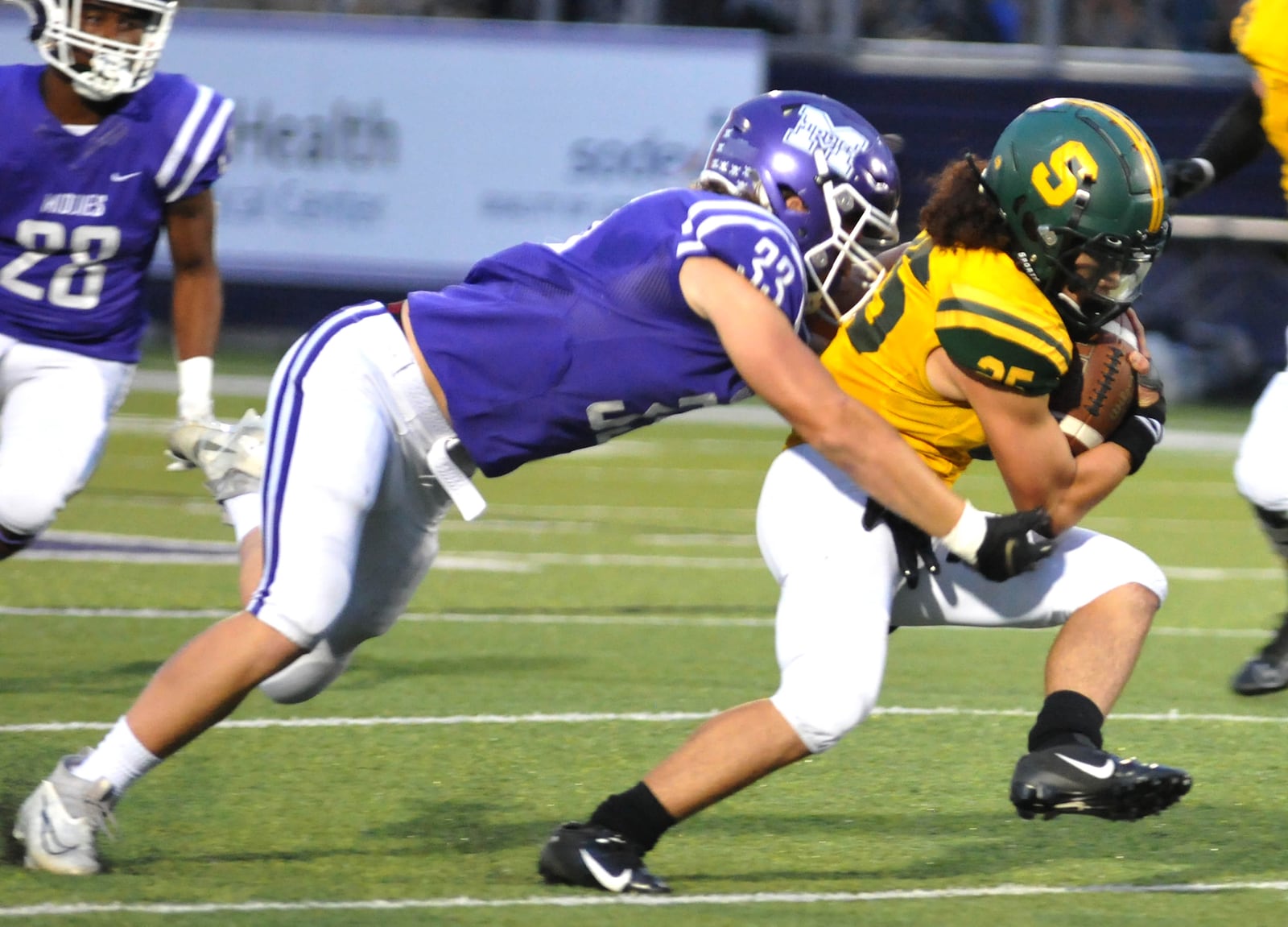 Middletown's Gabe Terrell, 33, tackles a Sycamore ball carrier during the first quarter of a Greater Miami Conference game at Middletown on Friday, Sept. 25. DAVID A. MOODIE/CONTRIBUTING PHOTOGRAPHER