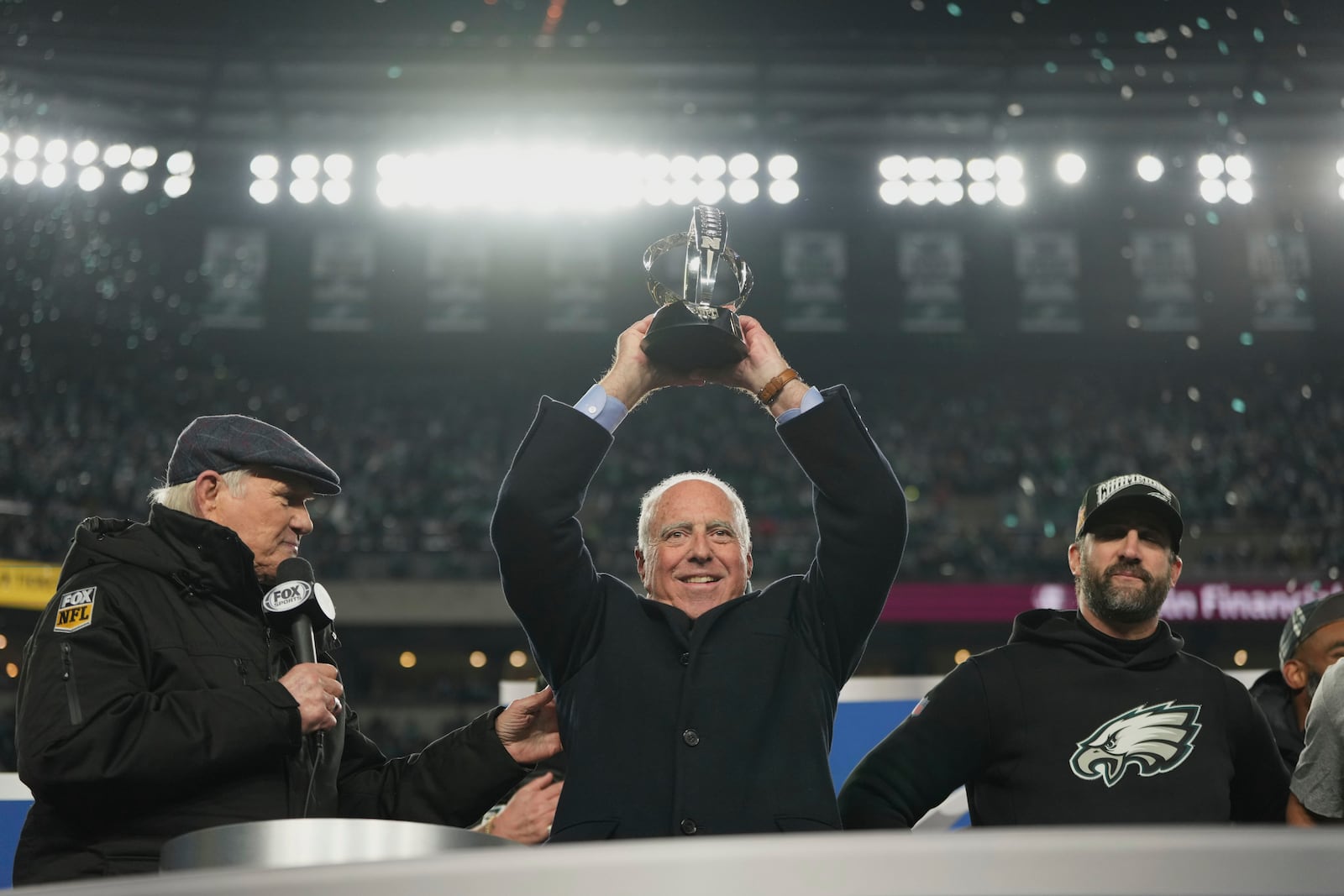 Philadelphia Eagles owner Jeffrey Lurie holds up the championship trophy after the Eagles won the NFC Championship NFL football game against the Washington Commanders, Sunday, Jan. 26, 2025, in Philadelphia. (AP Photo/Matt Slocum)