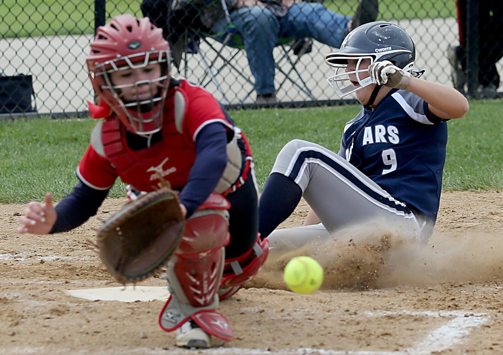 Talawanda catcher Lauren Baker goes after the throw as Edgewood’s Ally Williams scores during the Cougars’ 13-1 win in Oxford on April 21. CONTRIBUTED PHOTO BY E.L. HUBBARD