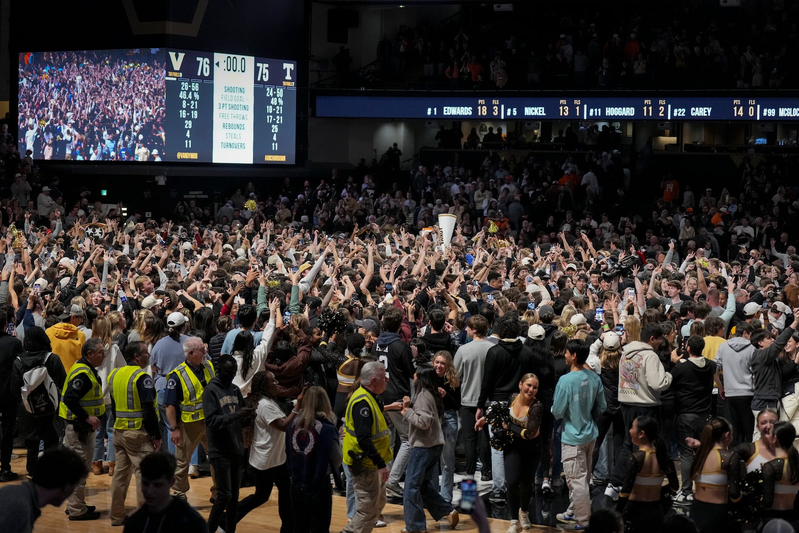 Vanderbilt fans storm the court after the team's win in an NCAA college basketball game against Tennessee, Saturday, Jan. 18, 2025, in Nashville, Tenn. (AP Photo/George Walker IV)