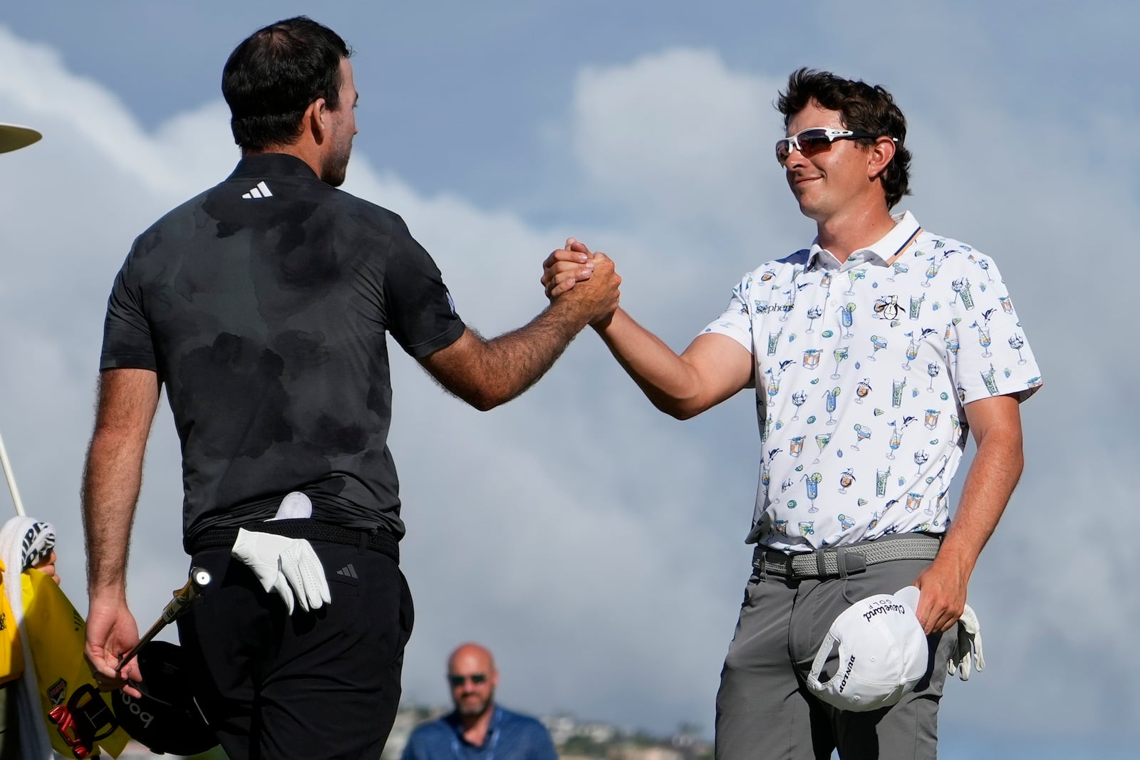 Nick Taylor, left, of Canada, is greeted by Nico Echavarria, of Columbia, after winning their playoff during the final round of the Sony Open golf event, Sunday, Jan. 12, 2025, at Waialae Country Club in Honolulu. (AP Photo/Matt York)