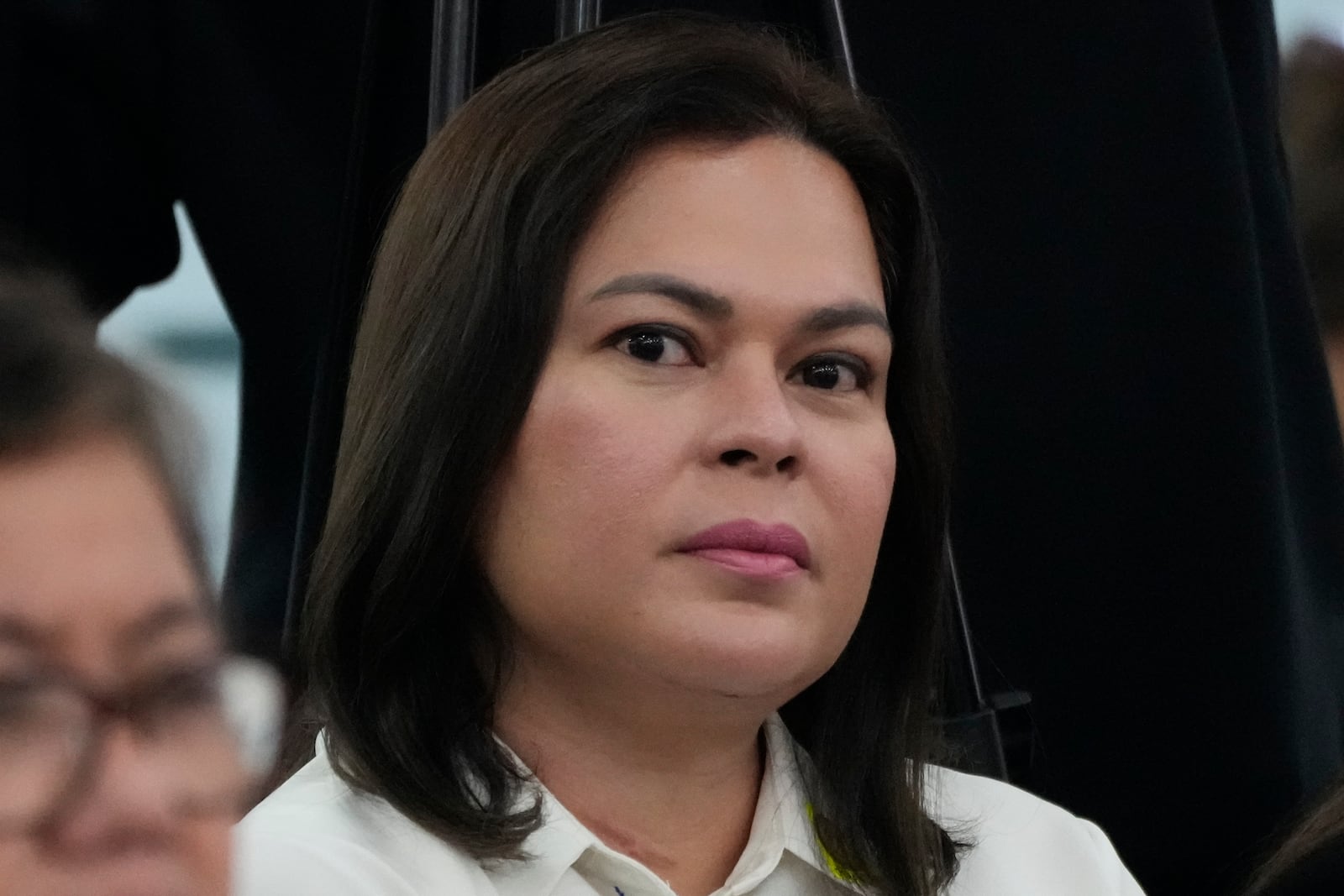 Philippine Vice President Sara Duterte listens as she attends a joint committee hearing of the House of Representatives in Quezon City, Philippines on Wednesday, Nov. 13, 2024, investigating the war on drugs during the administration of his father former President Rodrigo Duterte. (AP Photo/Aaron Favila)