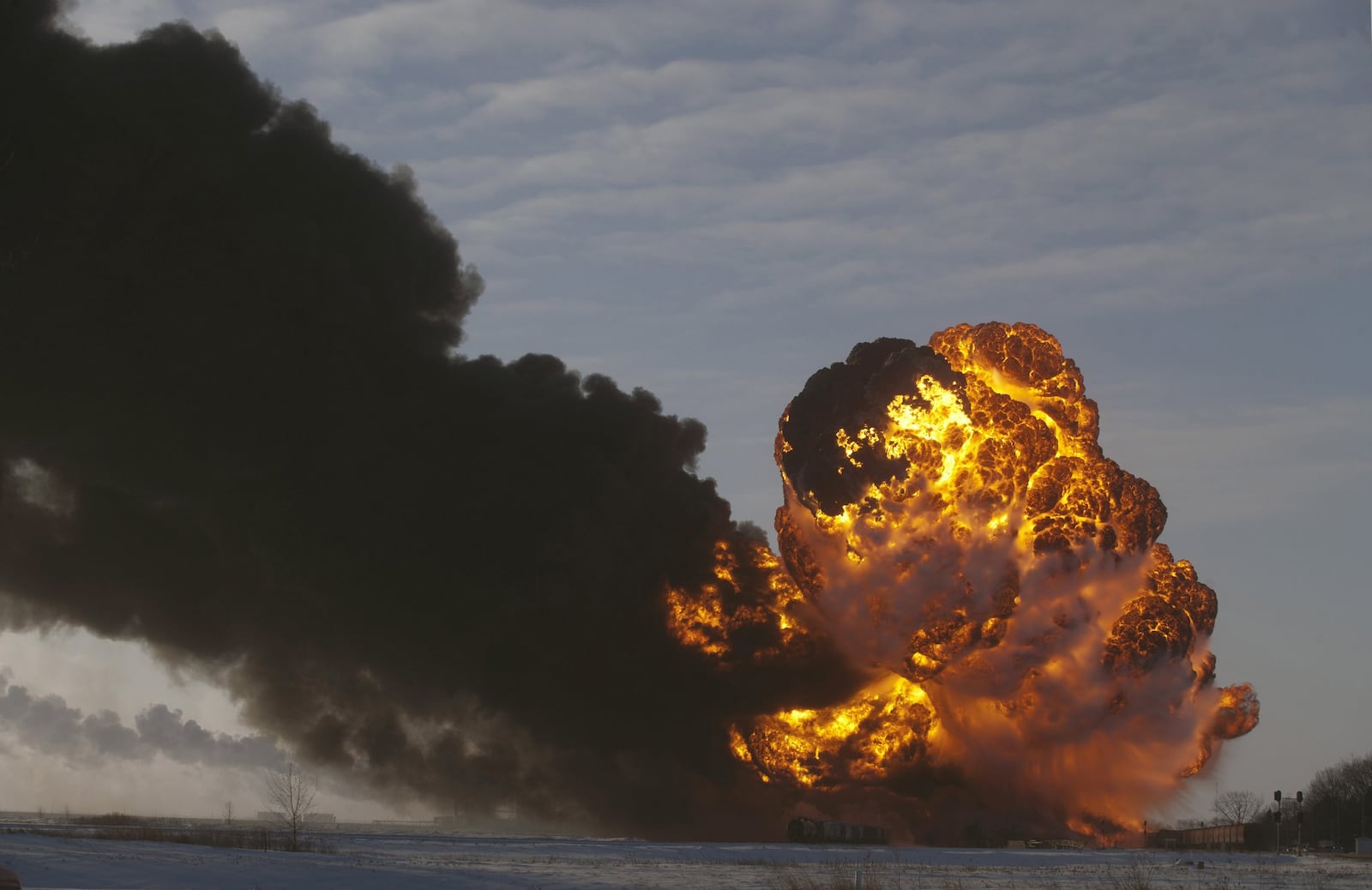 FILE - In this Dec. 30, 2013 file photo, a fireball goes up at the site of an oil train derailment in Casselton, N.D. Warning that a “major loss of life” could result from an accident involving the increasing use of trains to transport large amounts of crude oil, U.S. and Canadian accident investigators urged their governments to take a series of safety measures. The oil train derailed and exploded near Casselton, N.D., creating intense fires. The accident occurred about a mile outside the town, and no one was hurt. Rail lines run through and alongside the town. (AP Photo/Bruce Crummy, File)