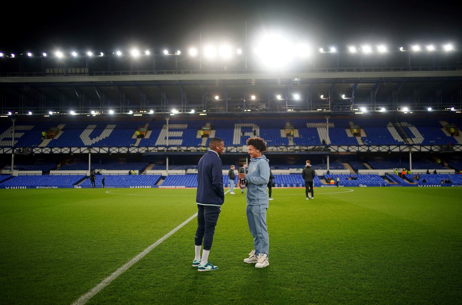 Everton's Ashley Young, left, speaks with his son, Peterborough United's Tyler Young, before the Emirates FA Cup third round match at Goodison Park, Liverpool, England, Thursday Jan. 9, 2025. (Peter Byrne/PA via AP)