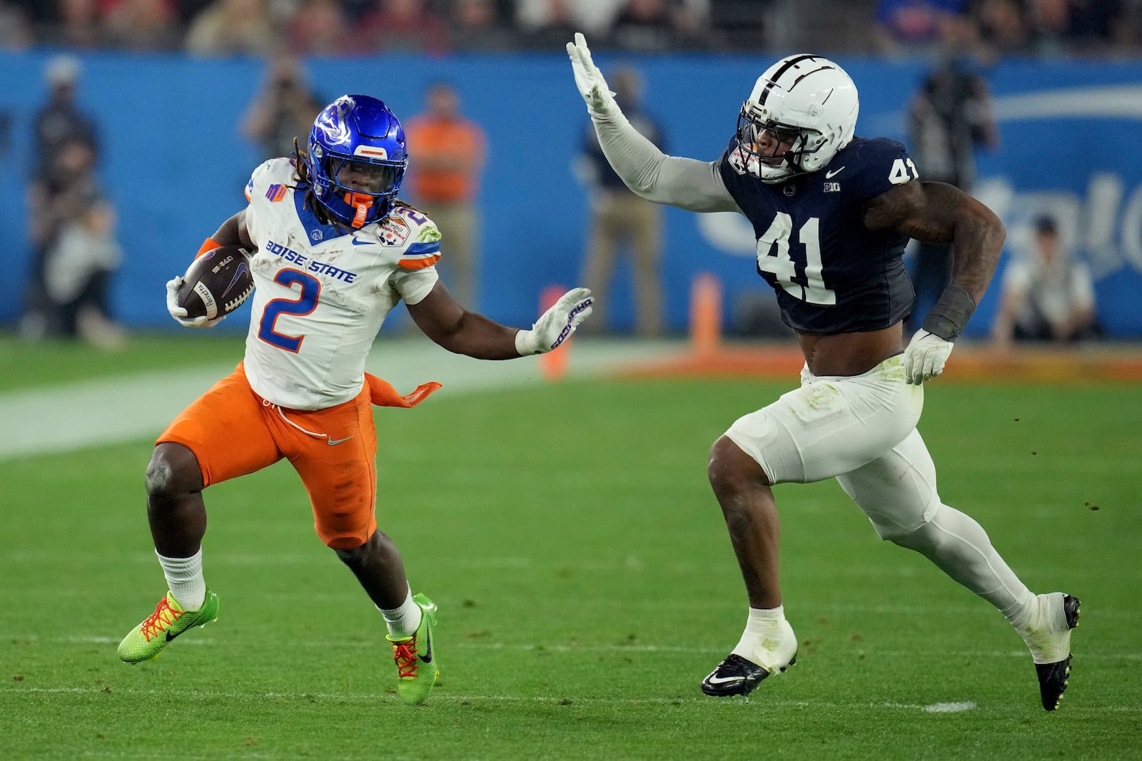 Boise State running back Ashton Jeanty (2) runs as Penn State linebacker Kobe King (41) pursues during the first half of the Fiesta Bowl NCAA college football CFP quarterfinal game, Tuesday, Dec. 31, 2024, in Glendale, Ariz. (AP Photo/Ross D. Franklin)