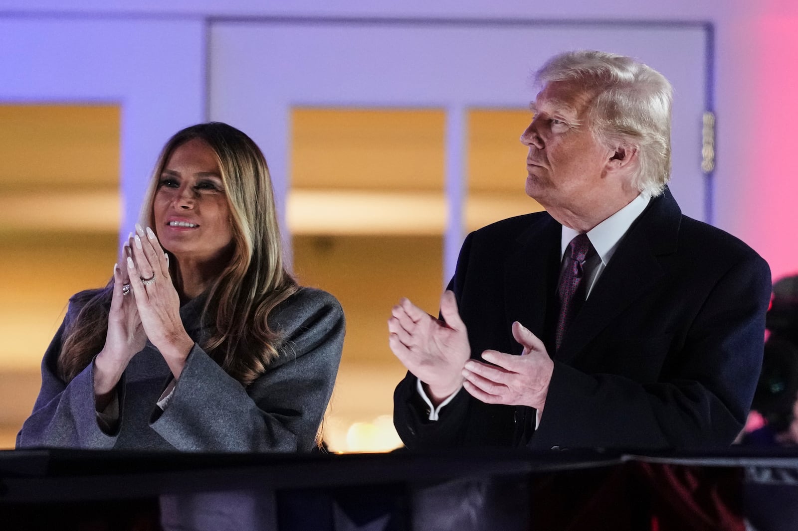 President-elect Donald Trump, right, and Melania Trump watch fireworks at Trump National Golf Club in Sterling, Va., Saturday, Jan. 18, 2025, ahead of the 60th Presidential Inauguration. (AP Photo/Matt Rourke)