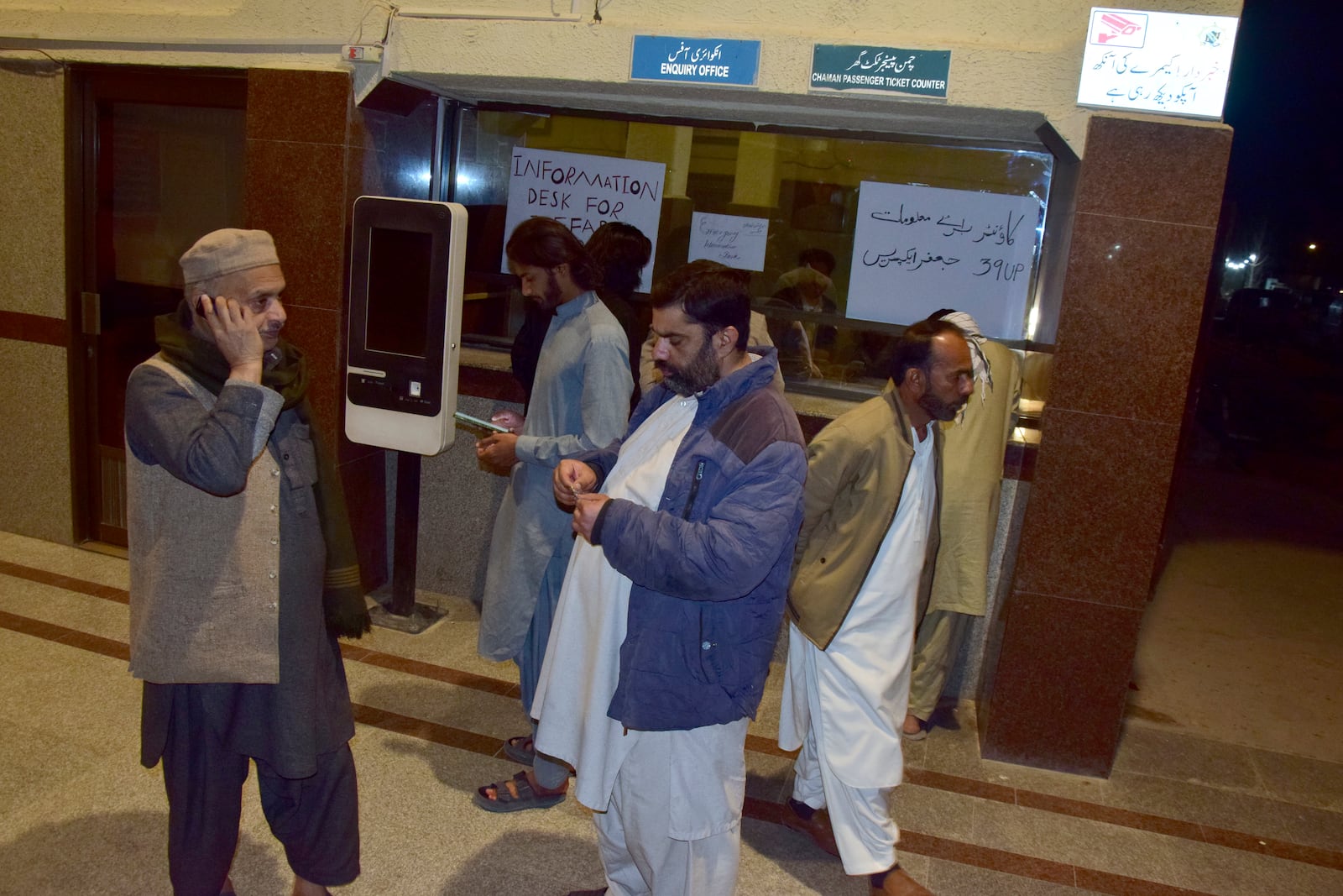 Relatives of passengers of a train, which is attacked by insurgents, gather to get information about passengers from special counter at a railway station in Quetta, Pakistan, Tuesday, March 11, 2025. (AP Photo/Arshad Butt)