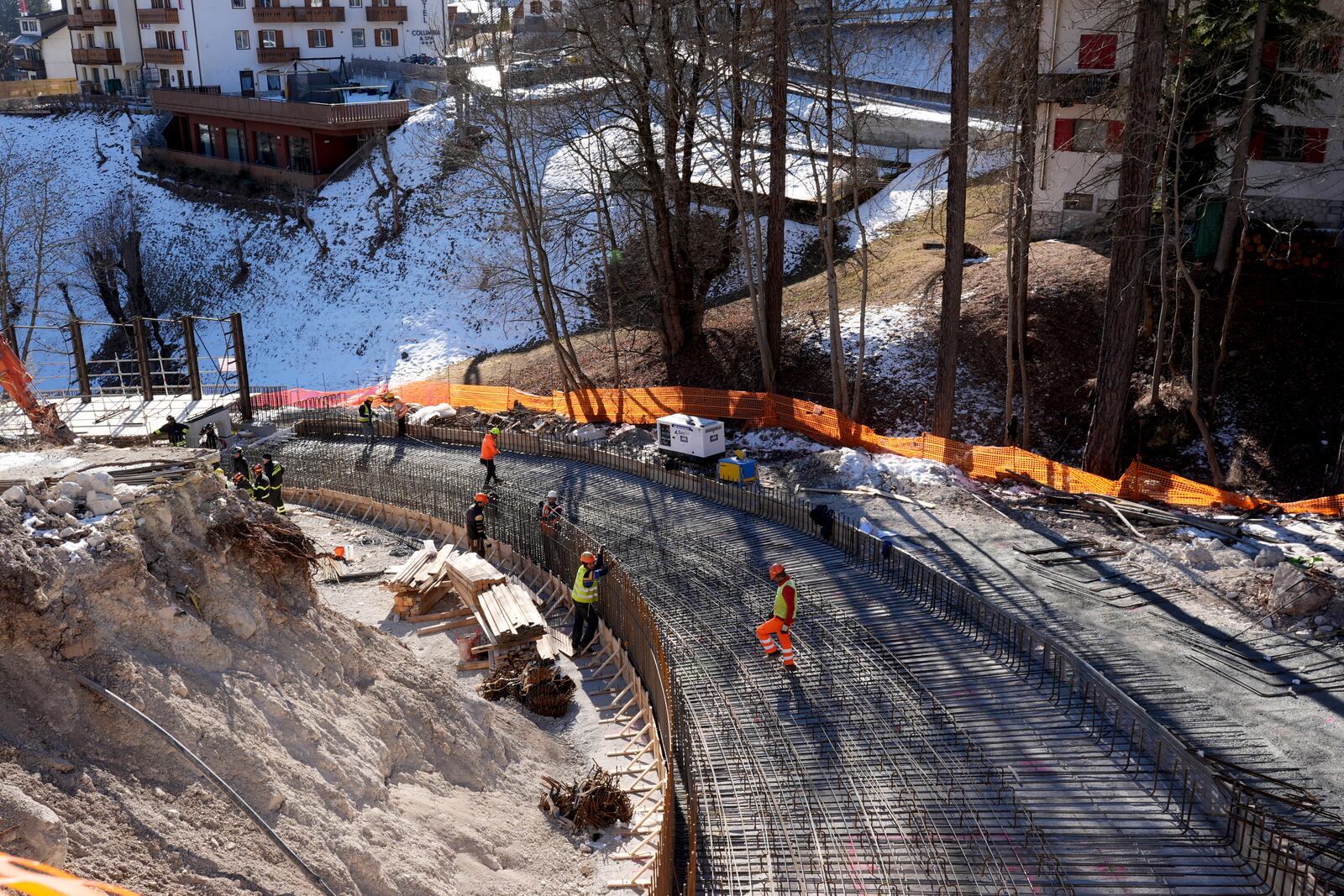 Construction work takes place at the Cortina Sliding Center, venue for the bob, luge and skeleton disciplines at the Milan Cortina 2026 Winter Olympics, in Cortina d'Ampezzo, Italy, Thursday, Jan. 16, 2025. (AP Photo/Giovanni Auletta)