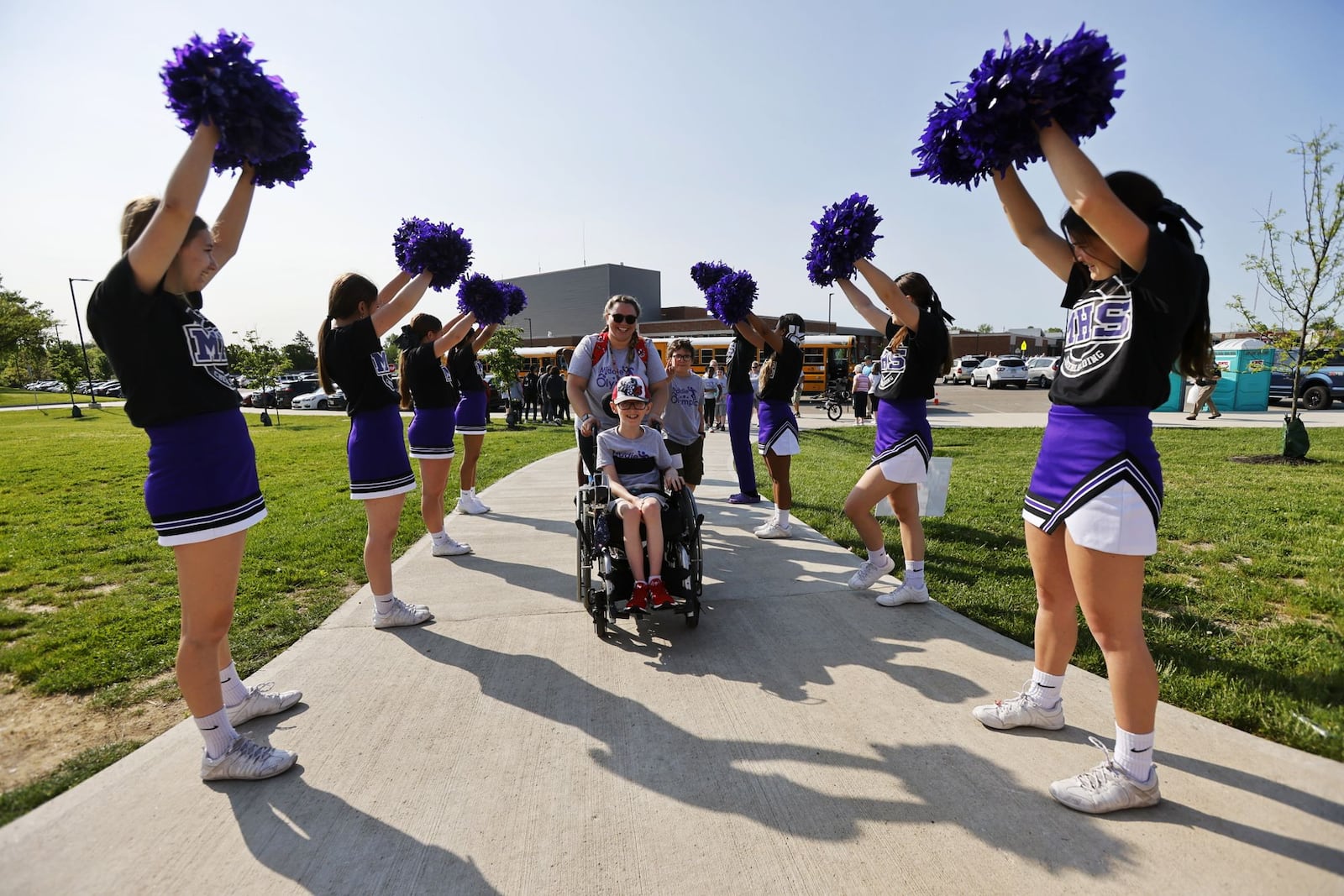 Cheerleaders greet Anderson Hayes, 10, and Amber Karkiewicz for Middie Olympics day Thursday, May 12, 2022 at Middletown High School. Community and student volunteers helped and students from all Middletown schools participated. NICK GRAHAM/STAFF