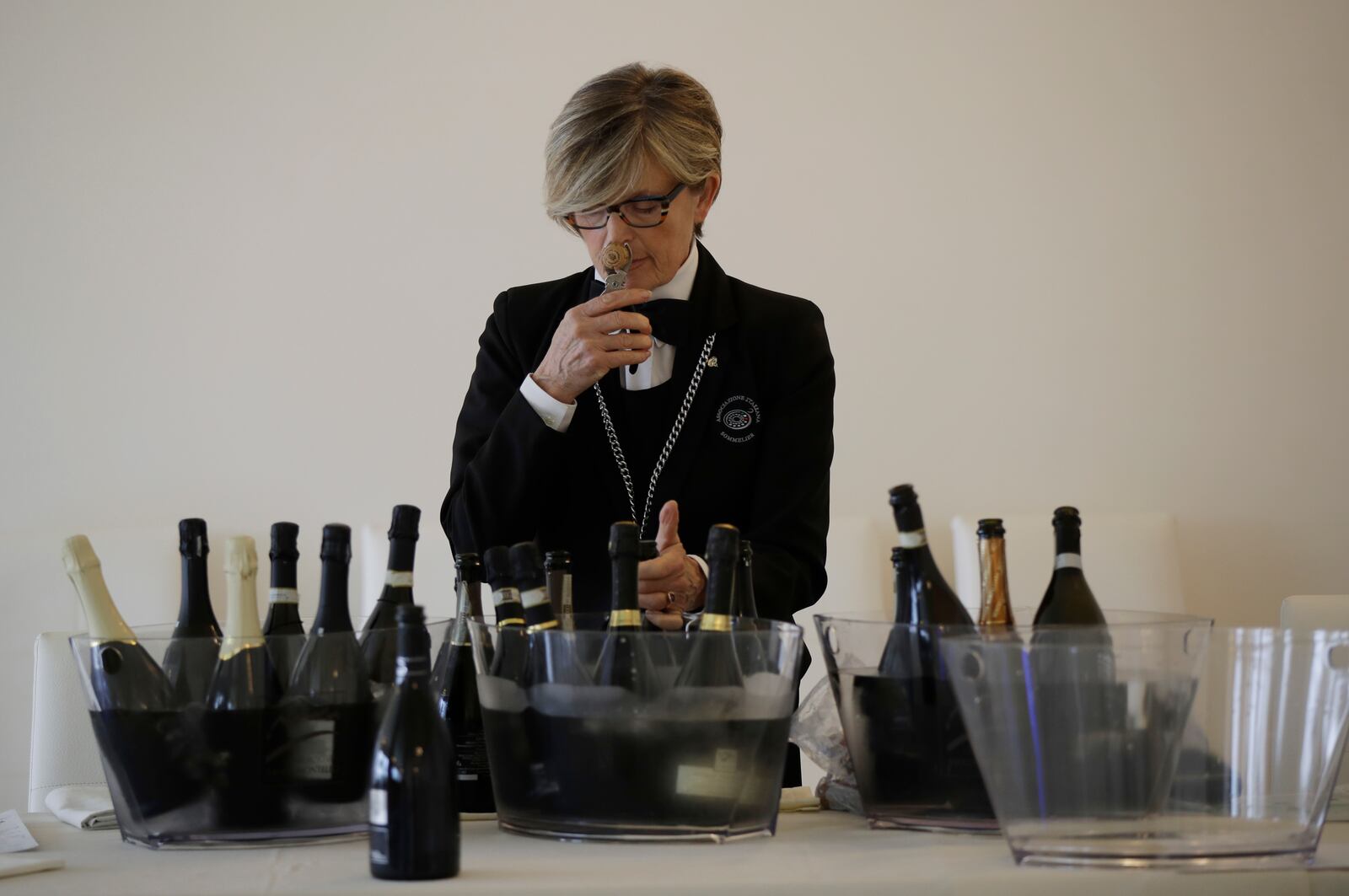 A sommelier opens Prosecco bottles during a wine testing in Asolo, Italy, Monday, Oct. 15, 2018. Global sales of prosecco the smooth, drinkable sparkling wine rooted in the northeastern hills of Italy are booming, and champagne, the original bubbly, is taking note. (AP Photo/Luca Bruno, File)