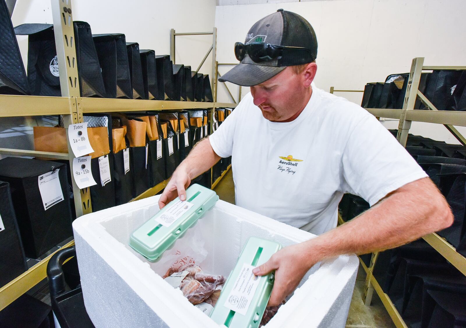 Jesse Stacey, with Grass Powered Poultry and Meats from Hillsboro, delivers goods to Market Wagon. 