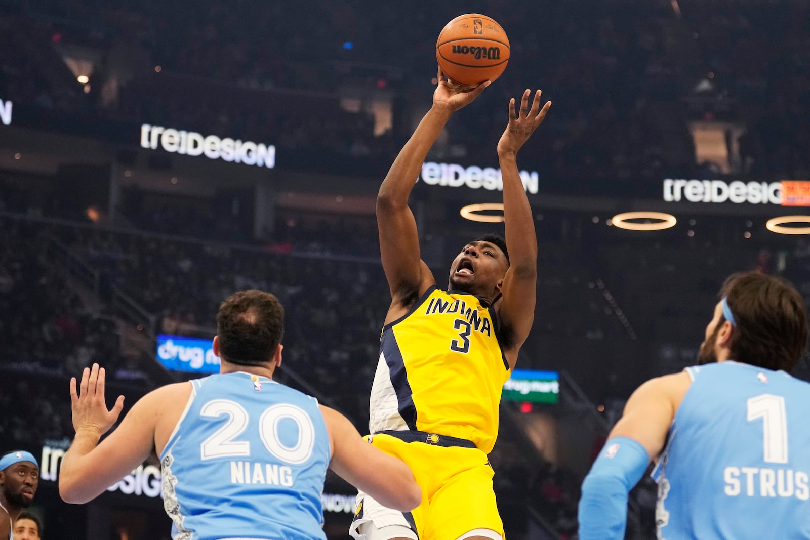 Indiana Pacers center Thomas Bryant (3) shoots in front of Cleveland Cavaliers forward Georges Niang (20) and Max Strus (1) in the first half of an NBA basketball game, Sunday, Jan. 12, 2025, in Cleveland. (AP Photo/Sue Ogrocki)