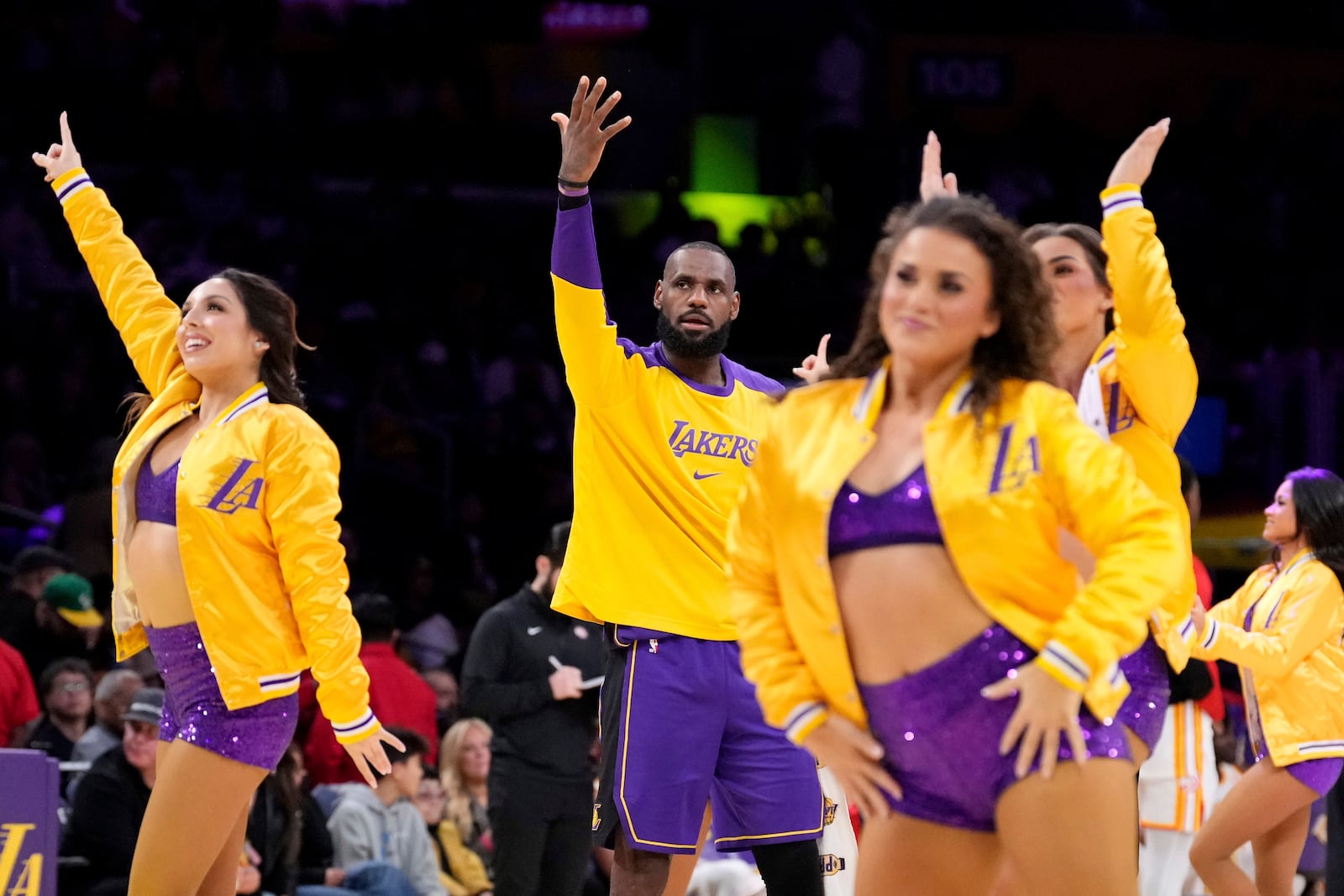 Los Angeles Lakers forward LeBron James, center, argues with a referee as members of the Laker Girls dance around him during timeout in the second half of an NBA basketball game against the Atlanta Hawks, Friday, Jan. 3, 2025, in Los Angeles. (AP Photo/Mark J. Terrill)