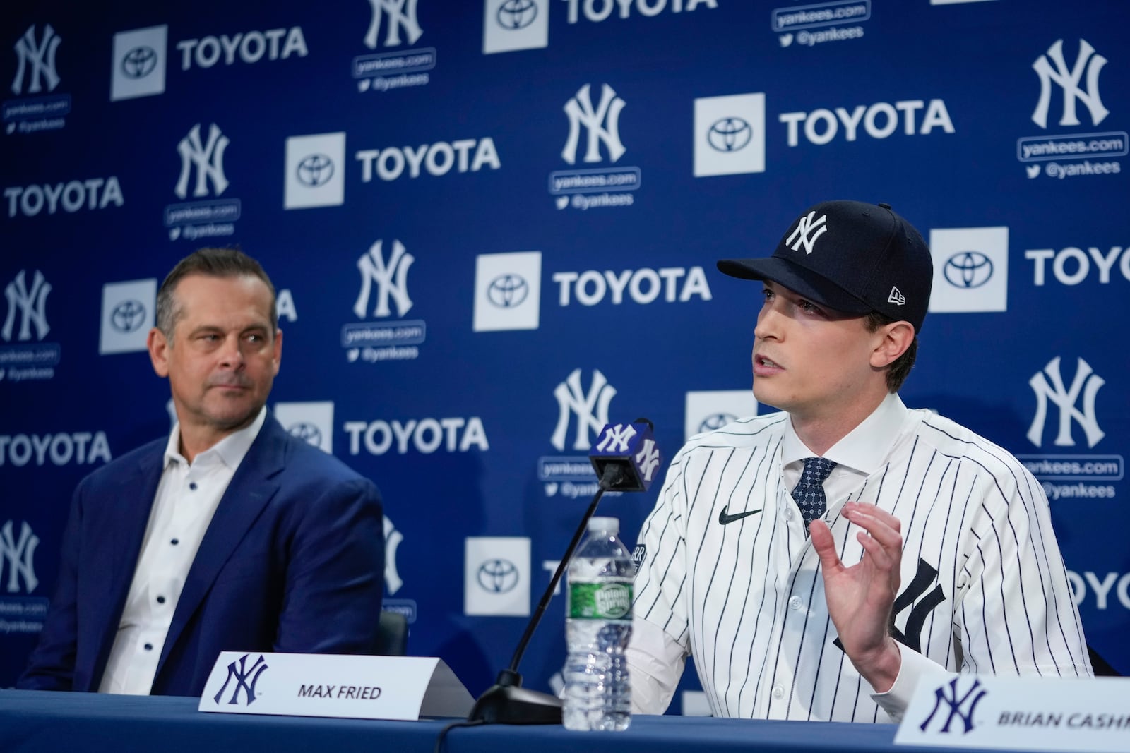 New York Yankees manager Aaron Boone, left, watches as Max Fried speaks during a baseball news conference, Wednesday, Dec. 18, 2024, in New York. (AP Photo/Frank Franklin II)