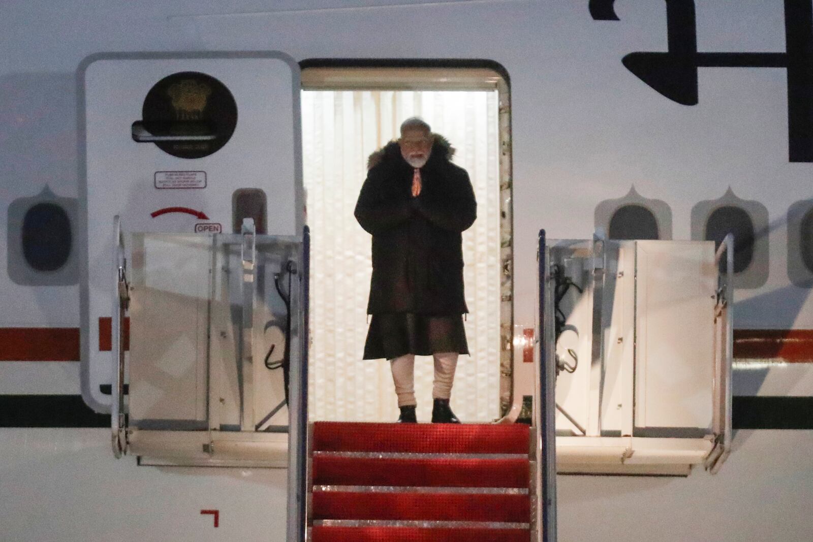 India's Prime Minister Narendra Modi walks down the stairs from his plane upon his arrival at Joint Base Andrews, Md., Wednesday, Feb. 12, 2025. (AP Photo/Luis M. Alvarez)