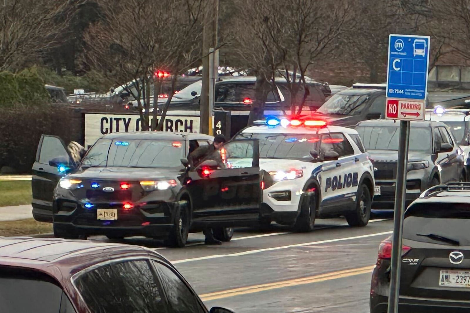 Emergency vehicles are parked outside the Abundant Life Christian School in Madison, Wis., where multiple injuries were reported following a shooting, Monday, Dec. 16, 2024. (AP Photo/Scott Bauer)