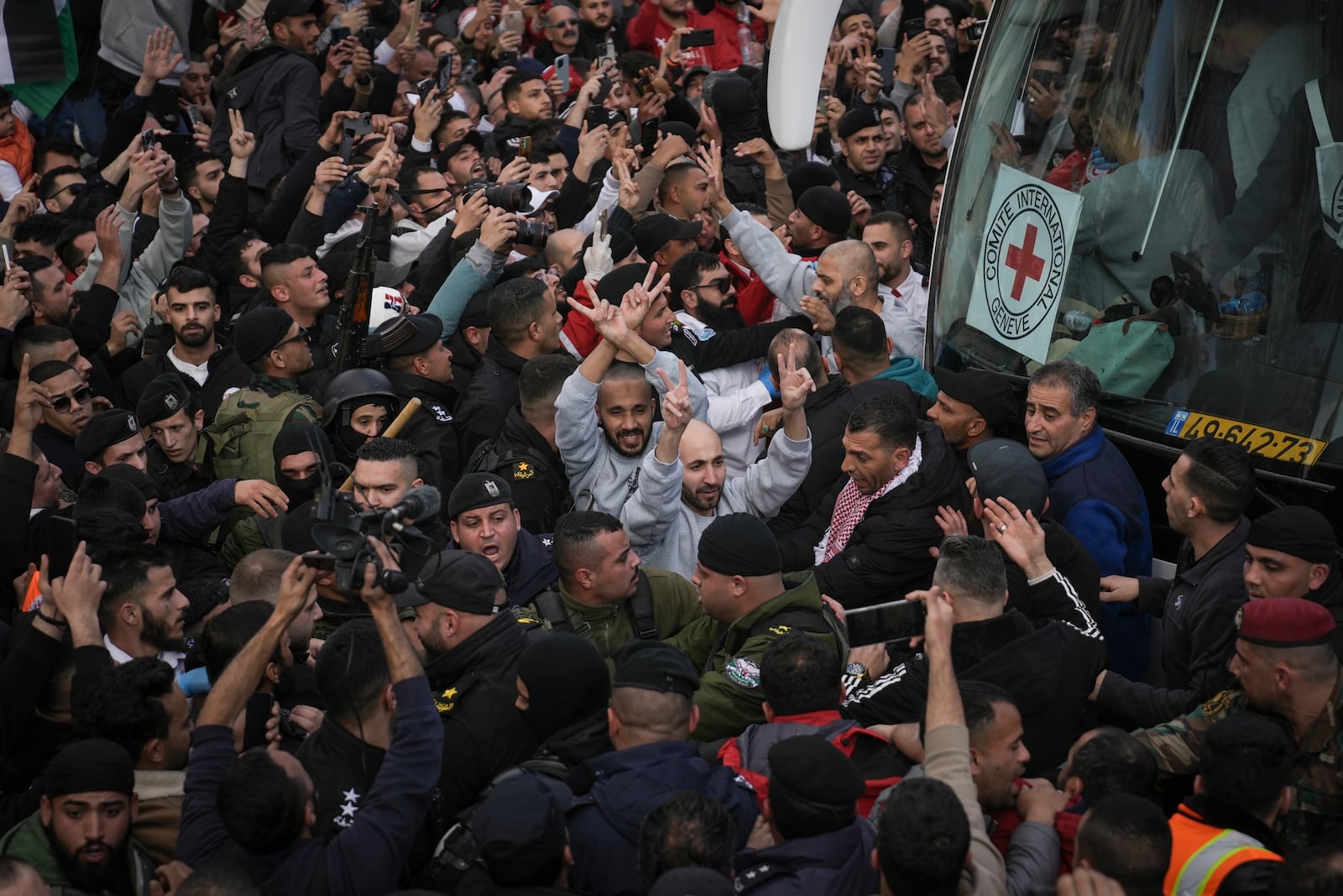 Palestinian prisoners are greeted by a crowd after being released from Israeli prison following a ceasefire agreement with Israel, in the West Bank city of Ramallah, Saturday, Jan. 25, 2025.(AP Photo/Mahmoud Illean)