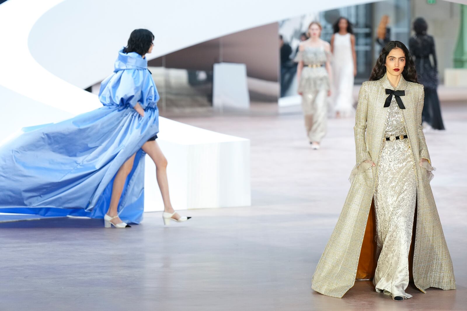 Models wear creations as part of the Chanel Haute Couture Spring Summer 2025 collection, that was presented in Paris, Tuesday, Jan. 28, 2025. (AP Photo/Lewis Joly).