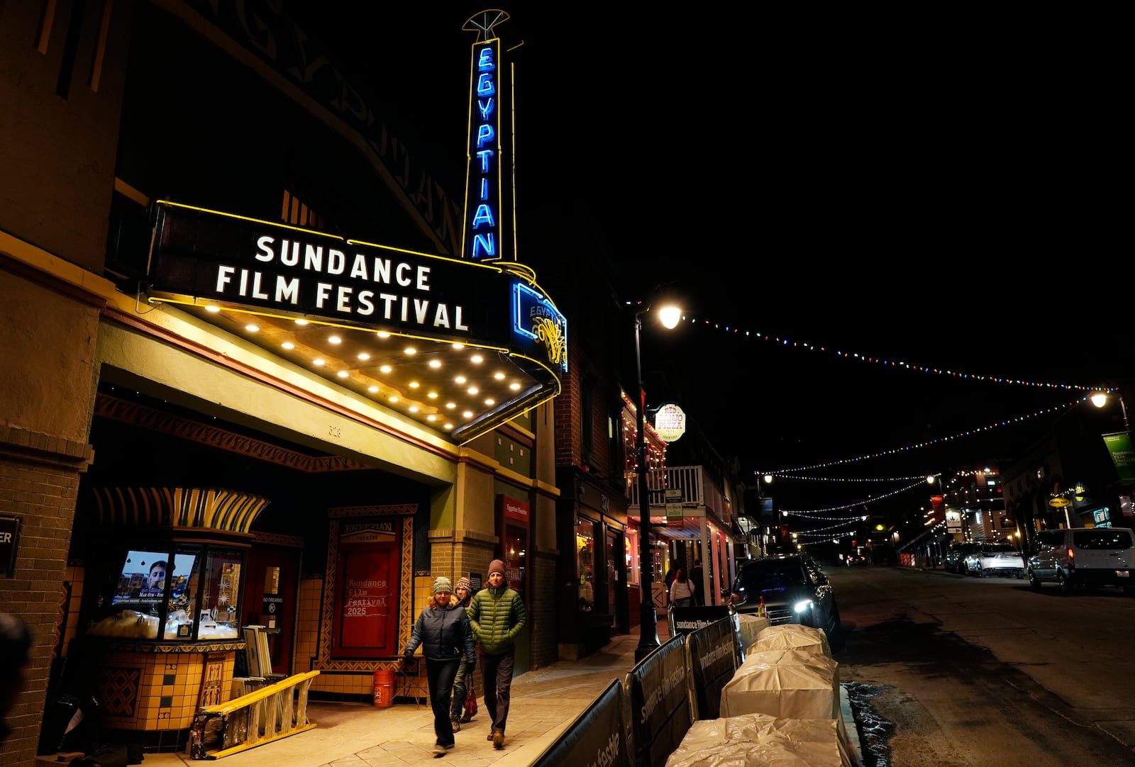 Pedestrians walk underneath the marquee of the Egyptian Theatre before the start of the Sundance Film Festival on Wednesday, Jan. 22, 2025, in Park City, Utah. (AP Photo/Chris Pizzello)