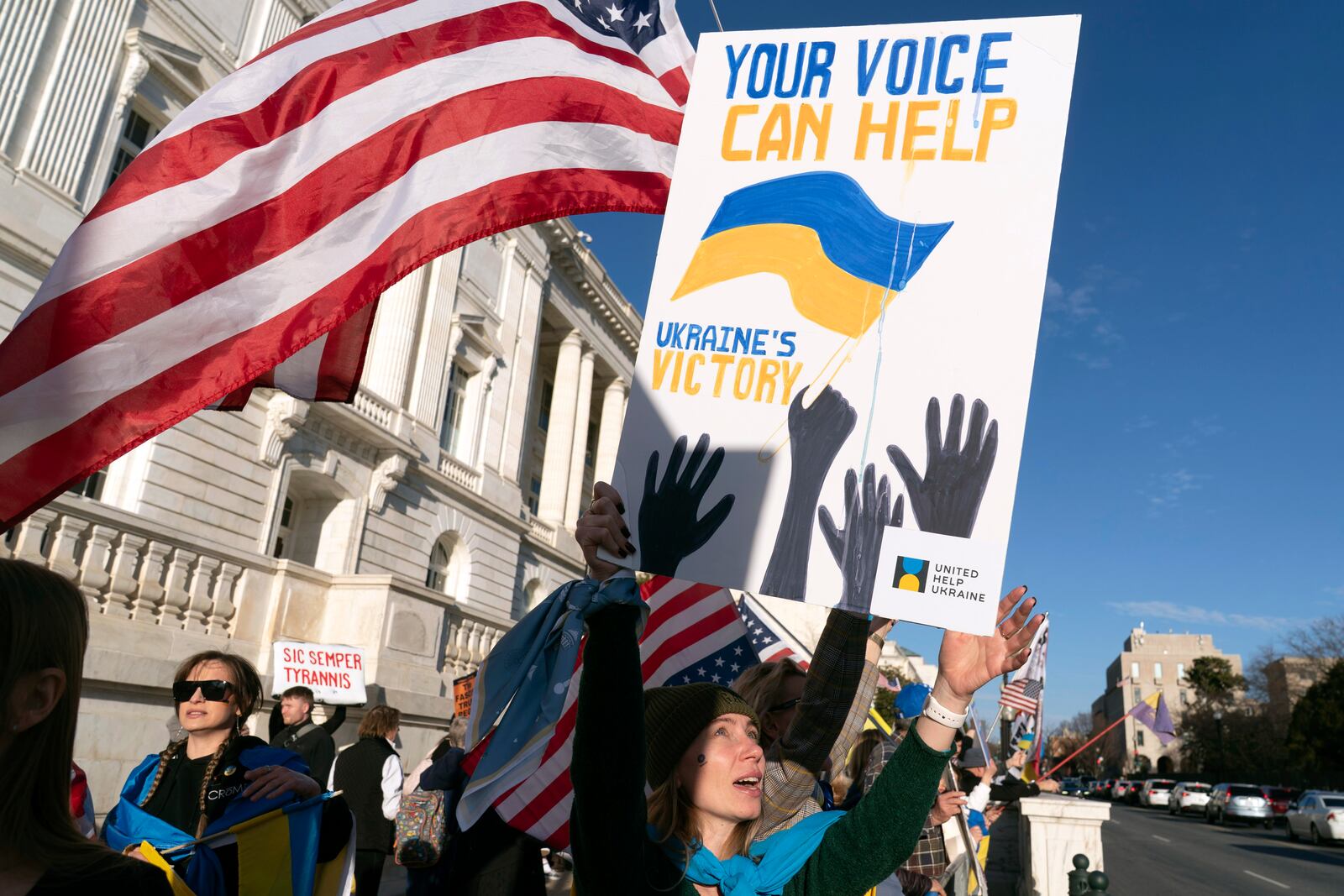 Demonstrators protest near the U.S. Capitol ahead of President Donald Trump address to a joint session of Congress in Washington, Tuesday, March 4, 2025. (AP Photo/Jose Luis Magana)