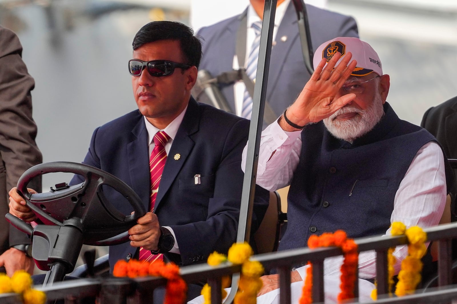 Indian Prime Minister Narendra Modi greets as he arrives for the commissioning ceremony of a submarine, a destroyer and a frigate built at a state-run shipyard in Mumbai, India, Wednesday, Jan. 15, 2025. (AP Photo/Rafiq Maqbool)