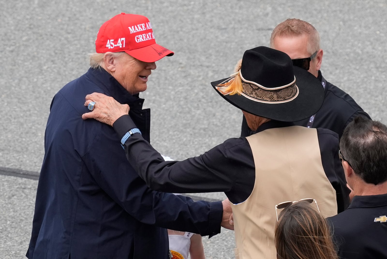 President Donald Trump, left, speaks with NASCAR Hall of Fame driver Richard Petty at the NASCAR Daytona 500 auto race at Daytona International Speedway, Sunday, Feb. 16, 2025, in Daytona Beach, Fla. (AP Photo/Chris O'Meara)