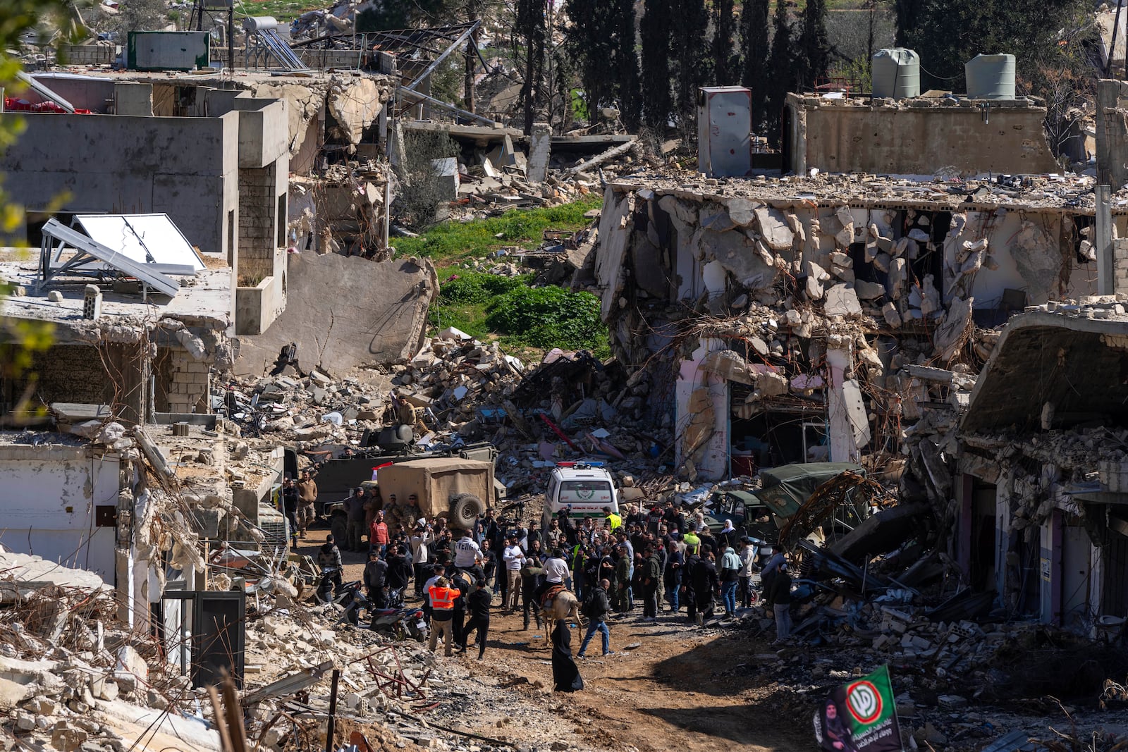 Lebanese people gather after they entered their destroyed hometown of Kfar Kila, southern Lebanon, Tuesday, Feb. 18, 2025. (AP Photo/Hassan Ammar)