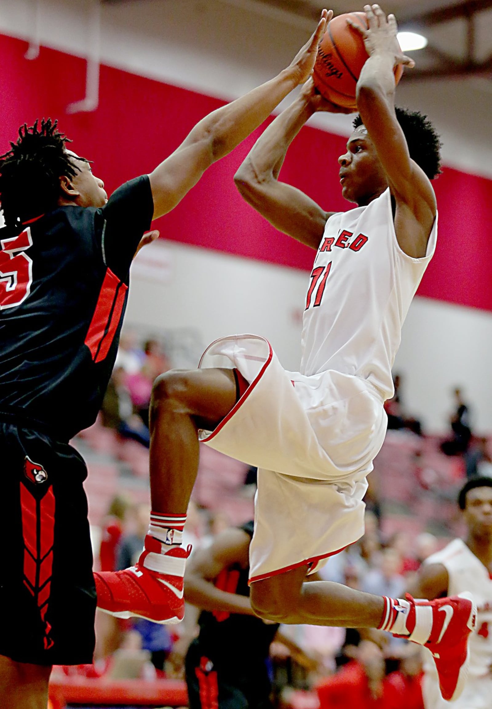 Fairfield guard Andre Givens scores despite the defense of Colerain’s Syncere Jones during Tuesday night’s game at Fairfield Arena. CONTRIBUTED PHOTO BY E.L. HUBBARD