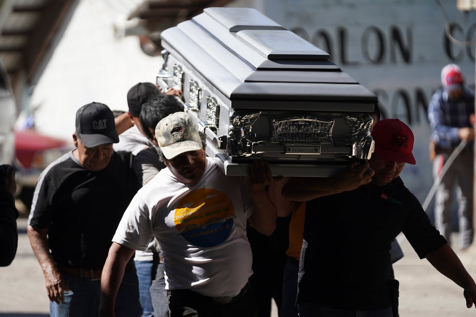 Pall bearers carry a coffin that contains the remains of a victim of a bus crash, at a funeral service in Santo Domingo Los Ocotes, Guatemala, Tuesday, Feb. 11, 2025. Dozens of passengers died after their bus plunged into a gorge and landed under a bridge on Feb. 10 on the outskirts of Guatemalan capital. (AP Photo/Moises Castillo)