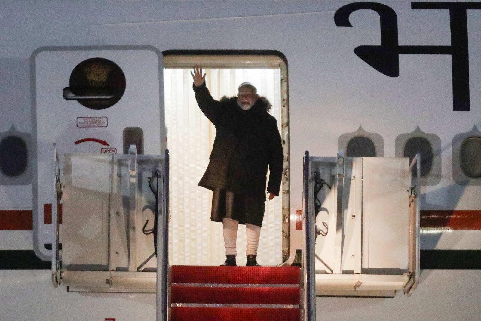 India's Prime Minister Narendra Modi waves from the stairs of his plane upon his arrival at Joint Base Andrews, Md., Wednesday, Feb. 12, 2025. (AP Photo/Luis M. Alvarez)