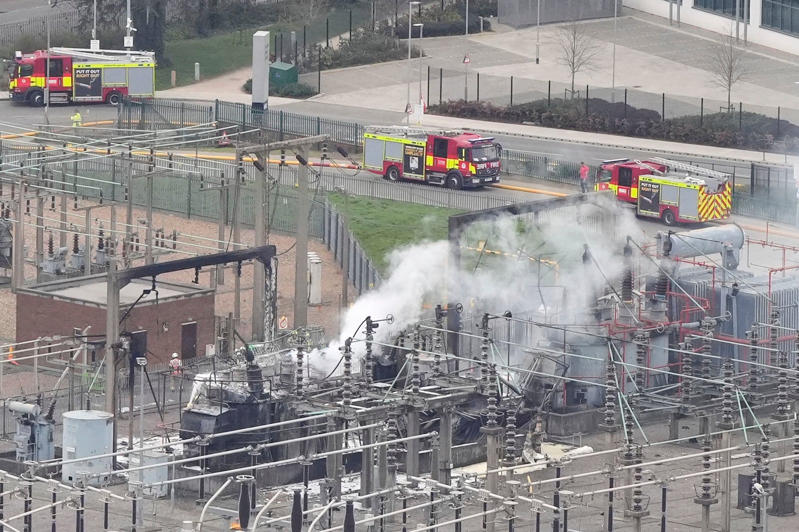 Smoke rises from the North Hyde electrical substation, which caught fire last night, leading to the closure of the Heathrow Airport, in London, Friday March 21, 2025. (Jonathan Brady/PA via AP)