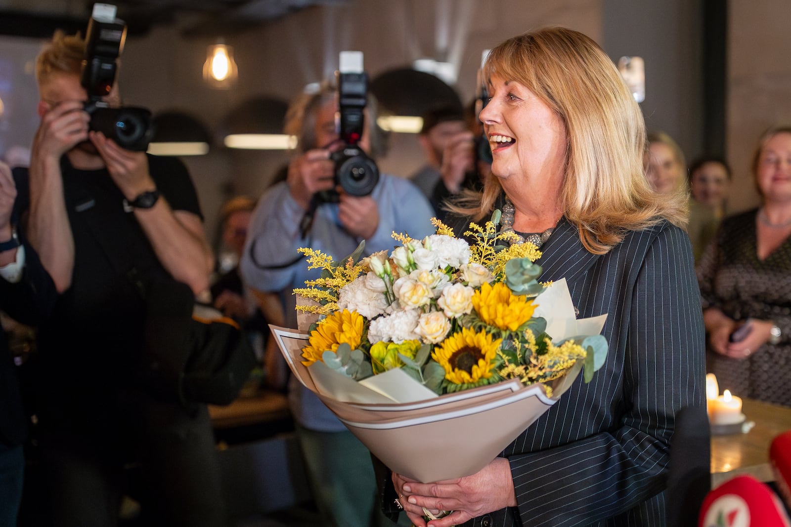 Leader of the Social Democratic Party Vilija Blinkeviciute smiles as she waits for the results of the first round of Lithuania's parliamentary election, in Vilnius, Lithuania, Sunday, Oct. 13, 2024. (AP Photo/Mindaugas Kulbis)