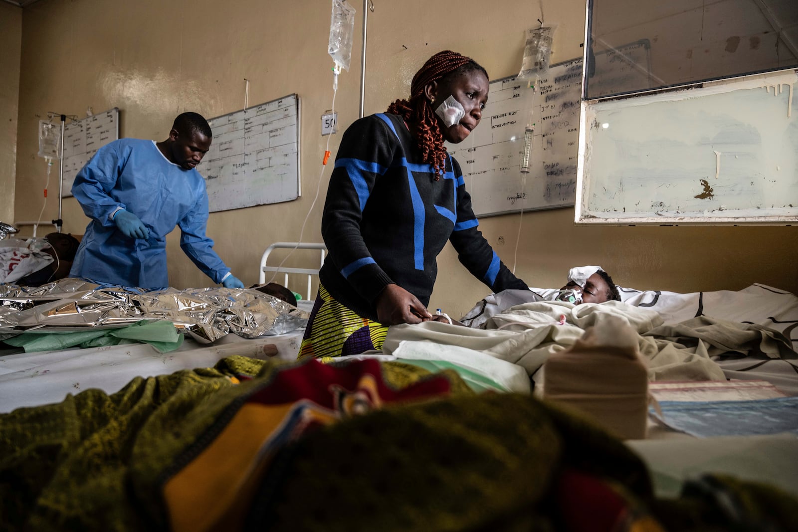 Mariam Nasibu stands by her 10-year-old daughter Deborah, who was wounded in the fighting between M23 rebels and Congolese armed forces, in Goma, Democratic Republic of the Congo, Thursday, Jan. 23, 2025. (AP Photo/Moses Sawasawa)