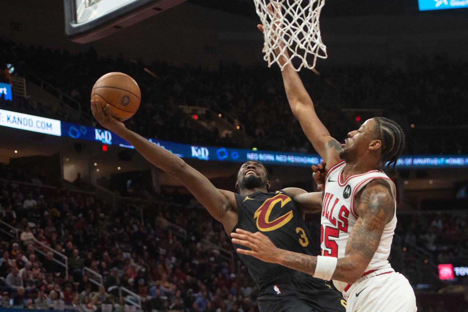 Cleveland Cavaliers' Caris LeVert (3) shoots as Chicago Bulls' Dalen Terry, right, defends during the second half of an Emirates NBA cup basketball game in Cleveland, Friday, Nov 15, 2024. (AP Photo/Phil Long)