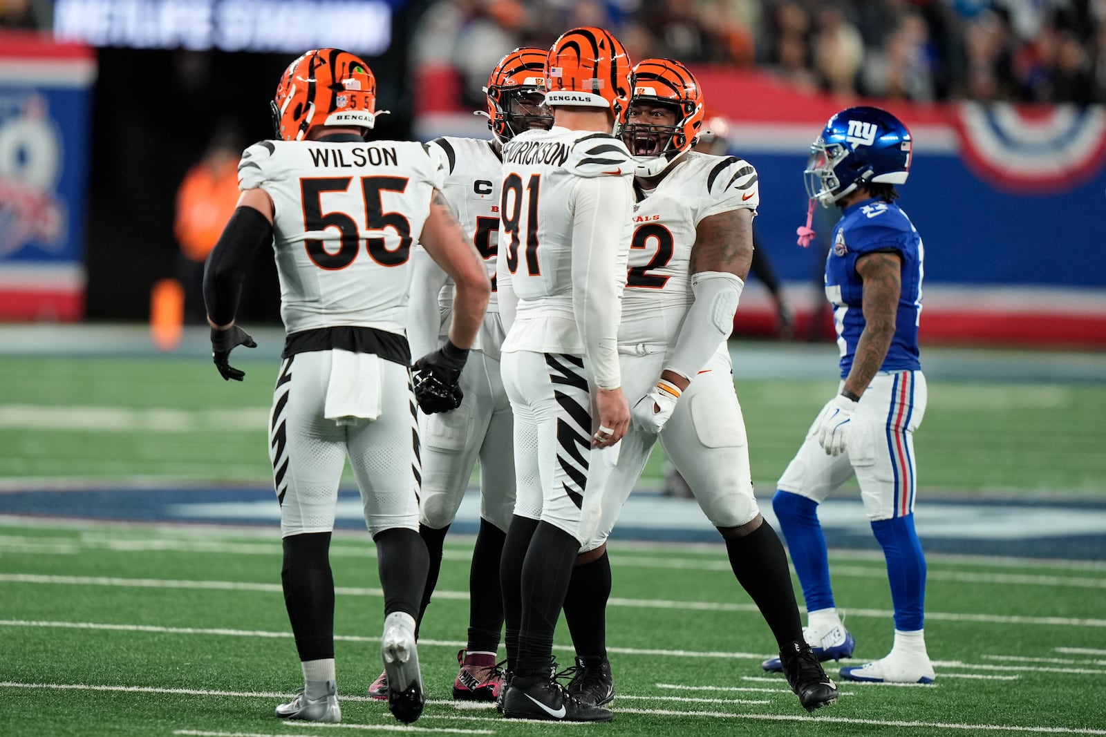 Cincinnati Bengals defensive end Trey Hendrickson (91) celebrates sacking New York Giants quarterback Daniel Jones, not pictured, with defensive tackle B.J. Hill (92) and linebacker Logan Wilson (55) during the second half of an NFL football game, Sunday, Oct. 13, 2024, in East Rutherford, N.J. The Bengals won 17-7. (AP Photo/Frank Franklin II)