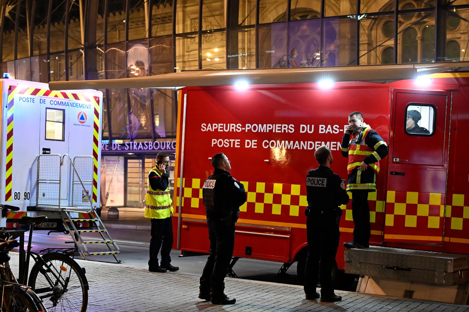 Police officers and rescue workers gather at the train station after two trams collided, injuring dozens of people, though none critically, firefighters said, Saturday, Jan. 11, 2025 in Strasbourg, eastern France. (AP Photo/Pascal Bastien)